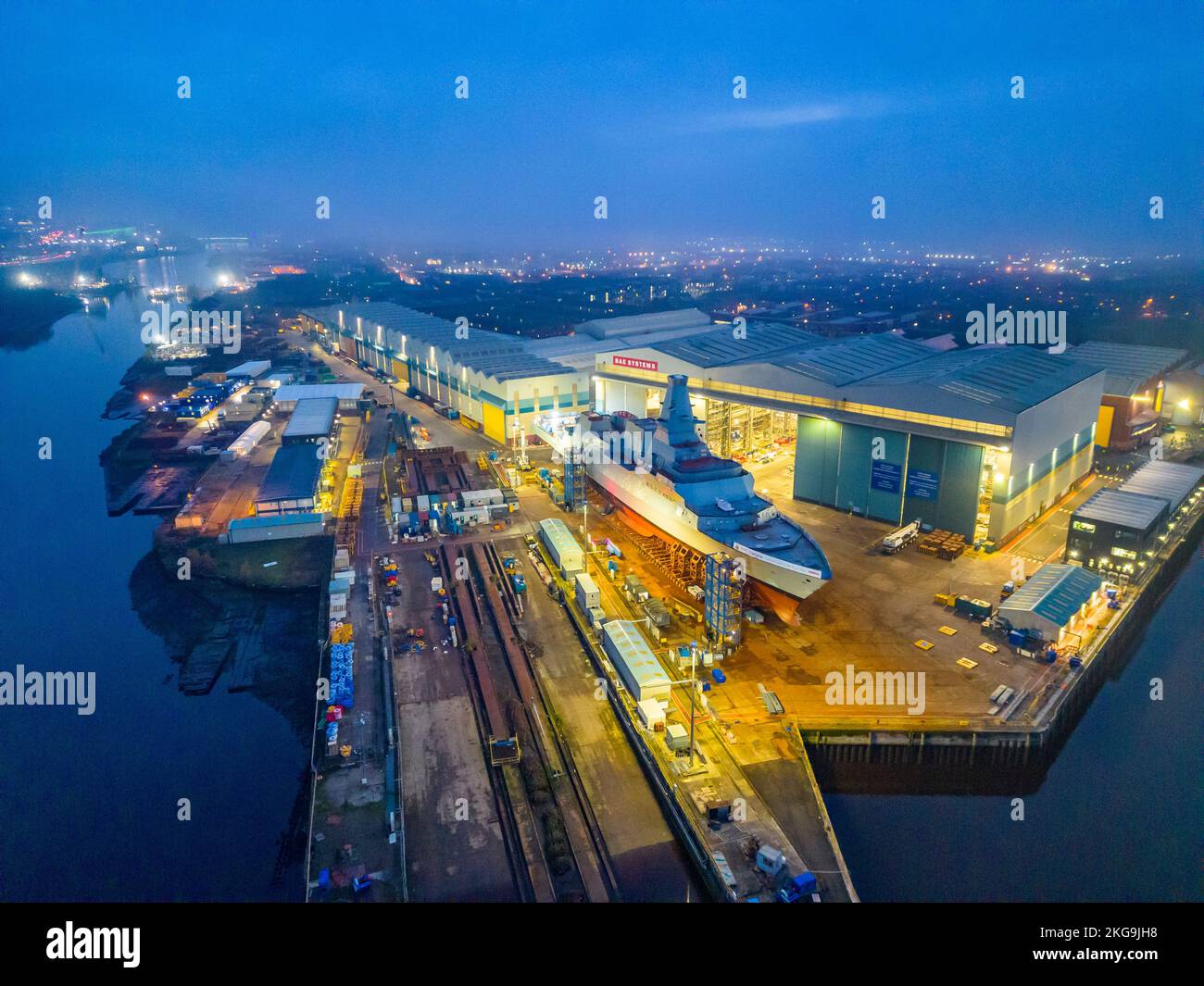 Glasgow, Scotland, UK. 22 November 2022. Aerial view of HMS Glasgow at BAE Systems Govan shipyard  just before being transferred by barge to nearby Scotstoun shipyard on the River Clyde. The ship is a Type 26 anti-submarine frigate.  Iain Masterton/Alamy Live News Stock Photo