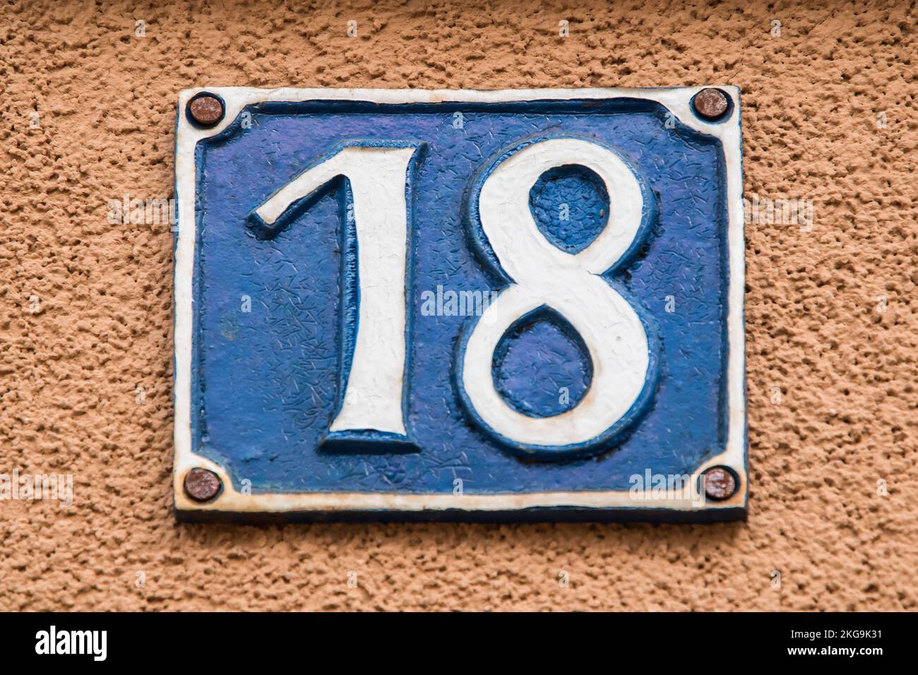 Old retro weathered cast iron plate number 18 closeup Stock Photo - Alamy