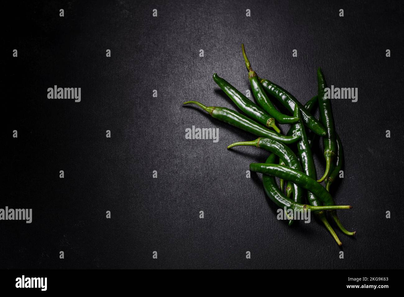Hot pepper of green color on a dark concrete background. Mexican ...
