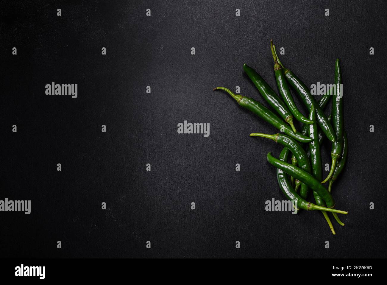 Hot pepper of green color on a dark concrete background. Mexican ...