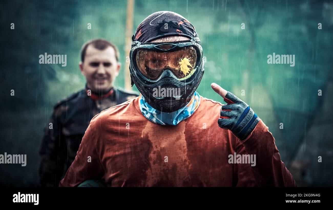 Paintball player under rain, equip for paintball Stock Photo Alamy