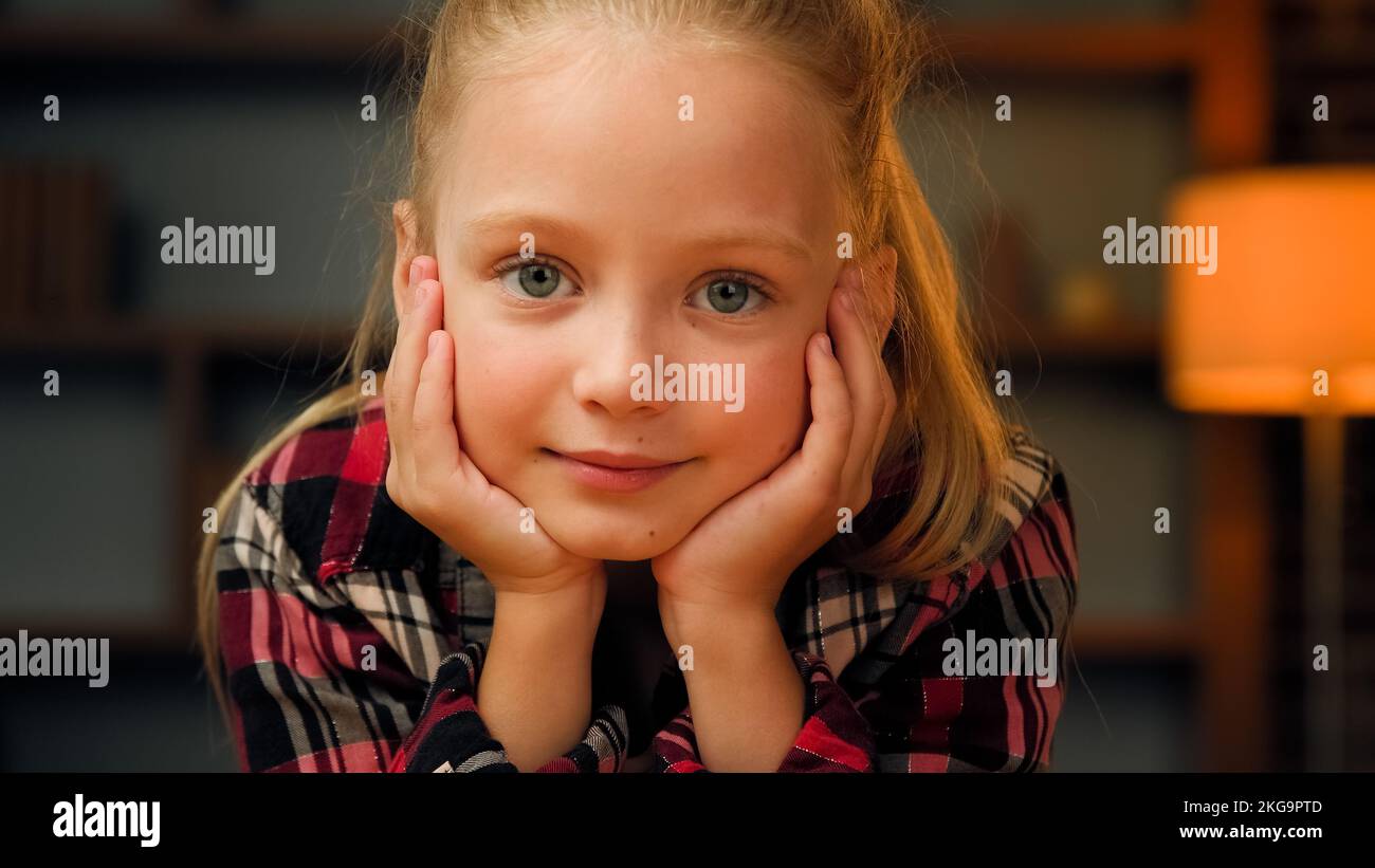 Child daughter cute girl looking at camera female kid portrait caucasian pretty baby in apartment close up human kid pretty young pupil teenager Stock Photo