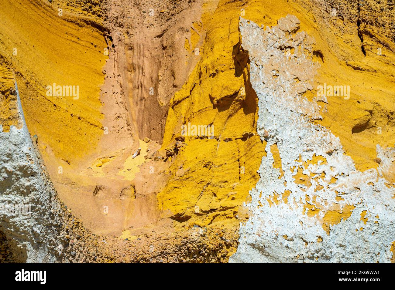 Multicolored yellow, mustard, honey colored colourful colorful rock slope texture weathering and erosion, patterns and textures of rock formation Stock Photo