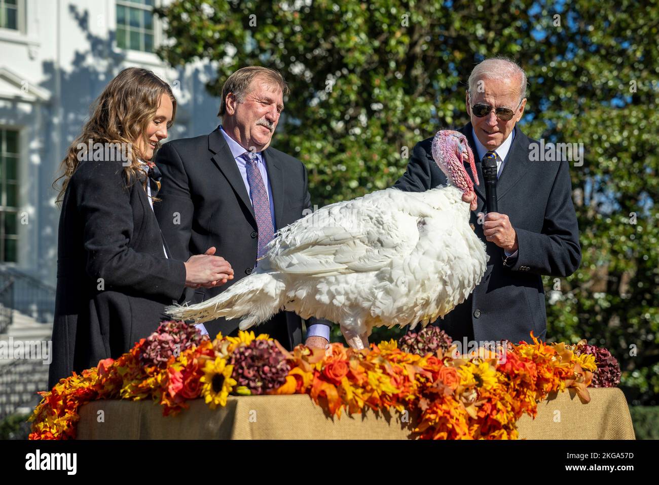 Washington, United States. 21st Nov, 2022. U.S. President Joe Biden, officially pardons a turkey named Chocolate, during the traditional Thanksgiving Turkey Pardon on the South Lawn of the White House, November 21, 2022 in Washington, DC Joining the president from left are: Alexa Starnes, daughter of the Circle S Ranch where the turkey was raised and Ronald Parker, Chairman of the National Turkey Federation. Credit: Adam Schultz/White House Photo/Alamy Live News Stock Photo