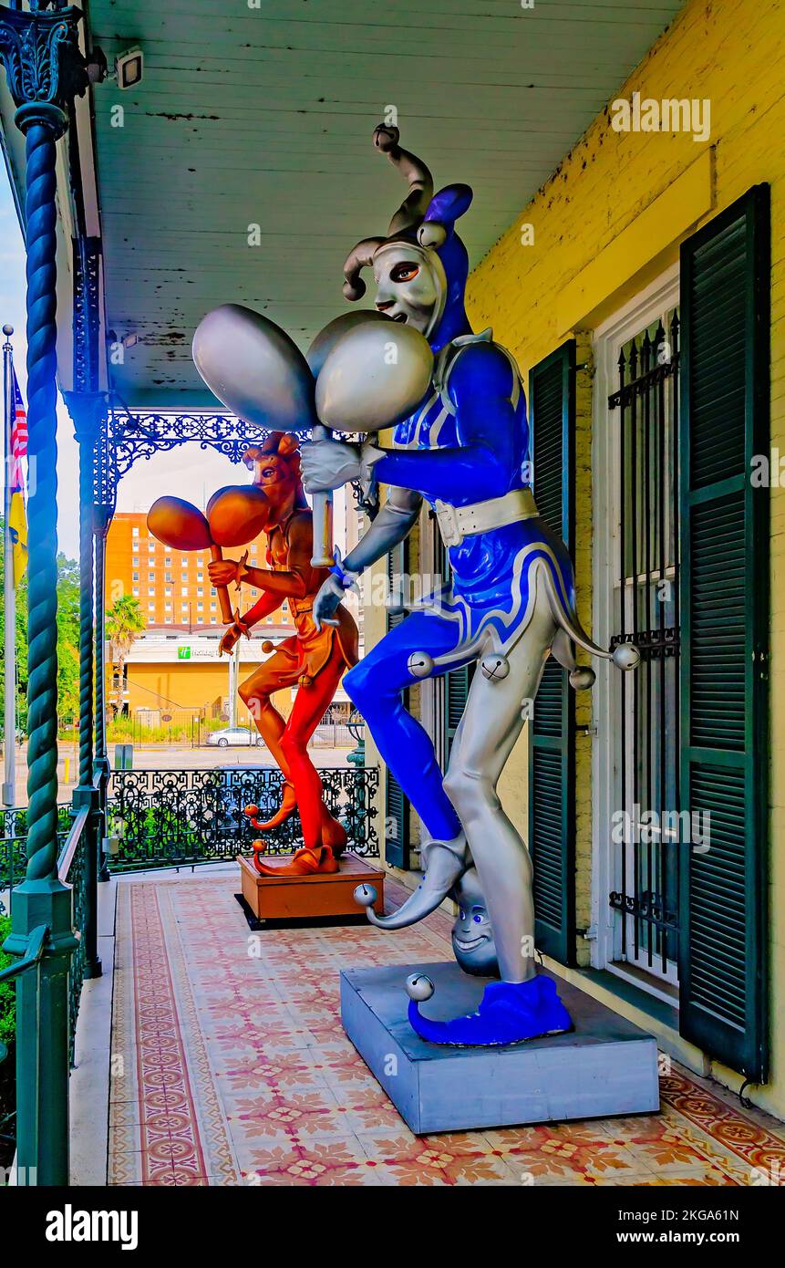 Mardi Gras jesters stand on the porch of the Mobile Carnival Museum