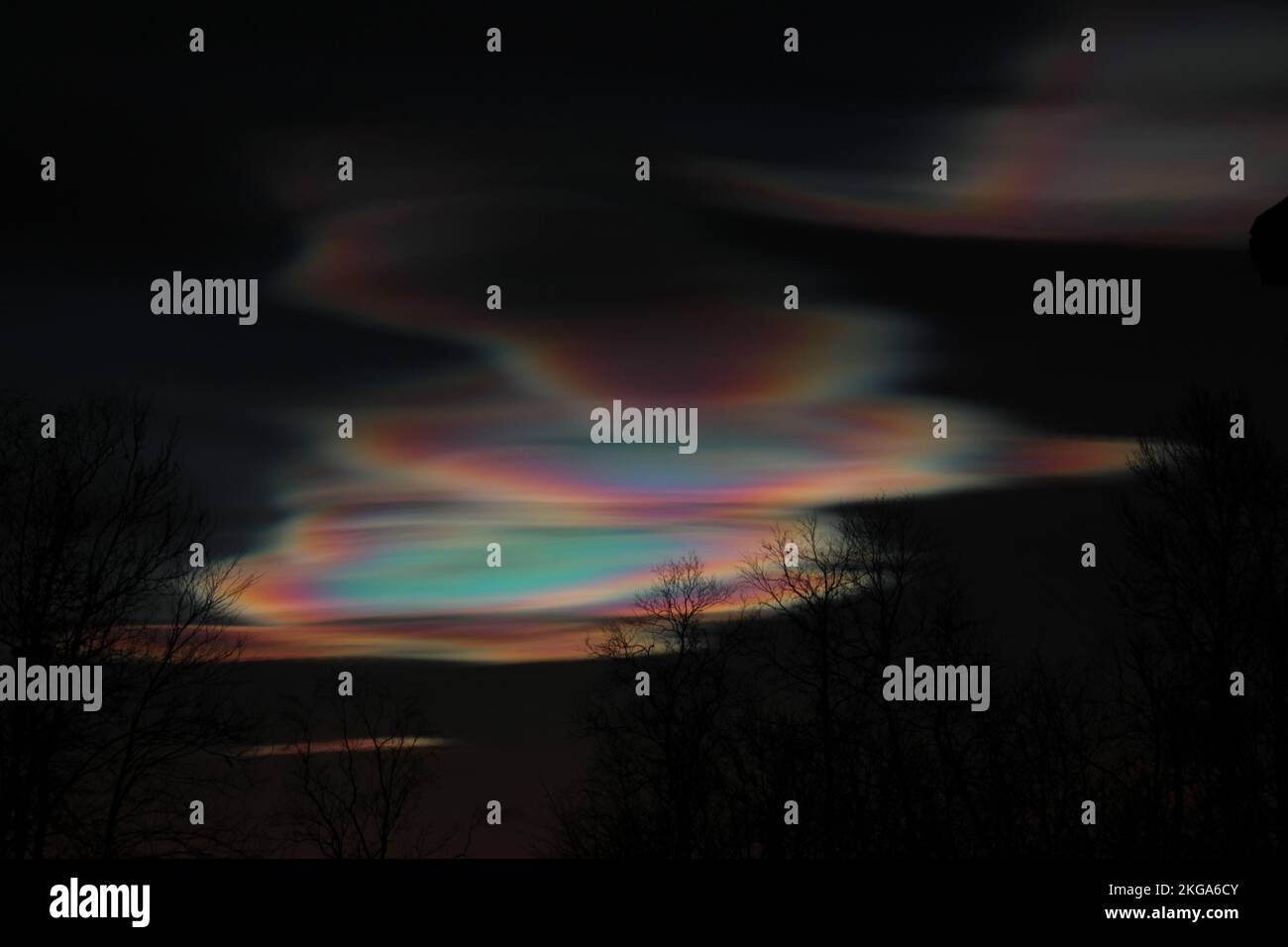 Polar stratospheric clouds, iridescent clouds, shining in the dark sky after sunset, in Kiruna, Sweden, in the Arctic Circle Stock Photo