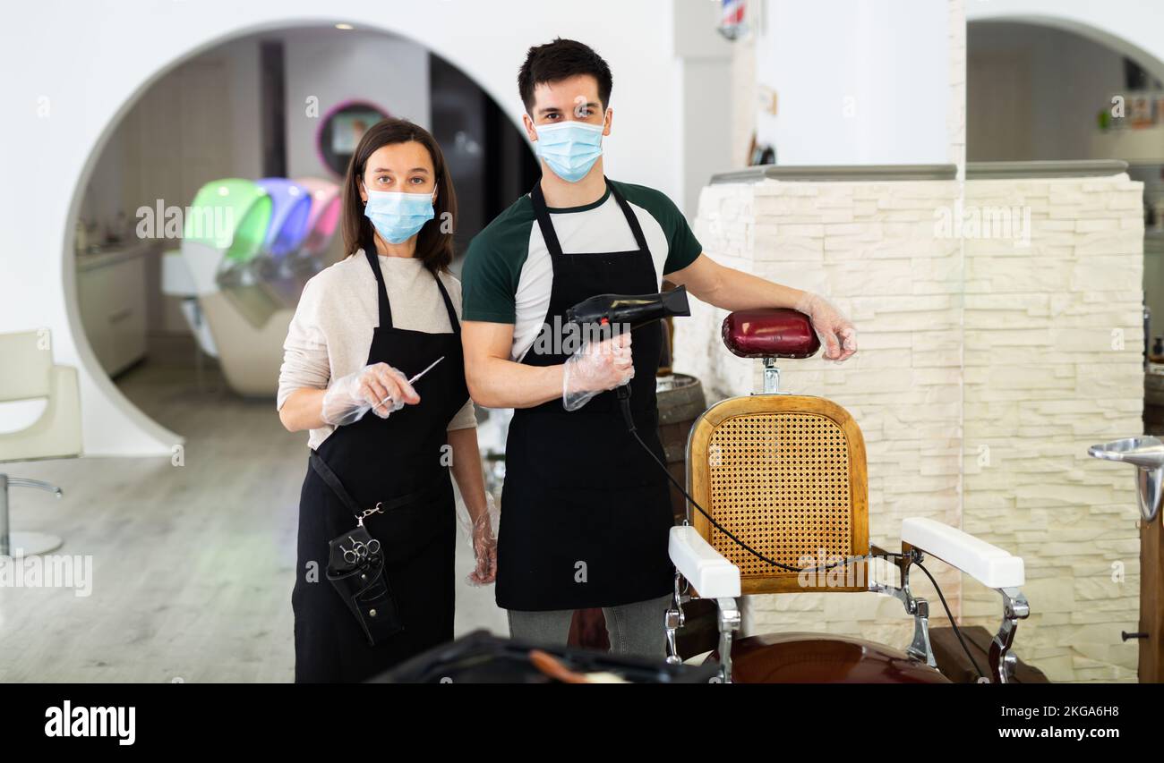 Two hairdressers in masks ready to work Stock Photo Alamy