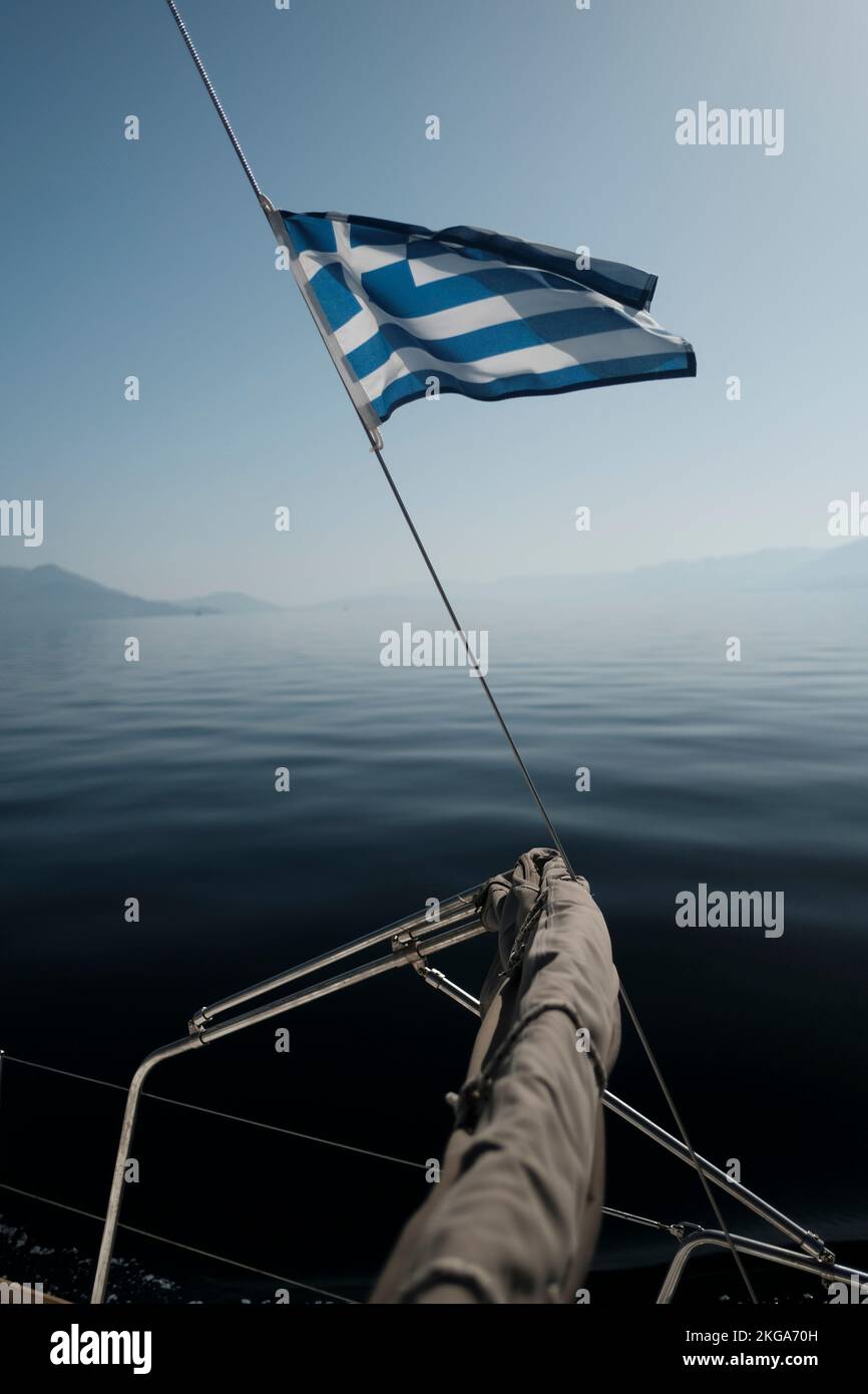 The greek flag flying from a sailing yacht in the Saronic Gulf, Greece Stock Photo