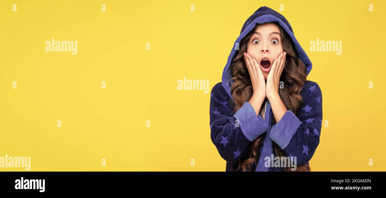 Shocked expression. Shocked child keeping dropped jaw with hands. Showing shock or great surprise. Child face, horizontal poster, teenager girl Stock Photo