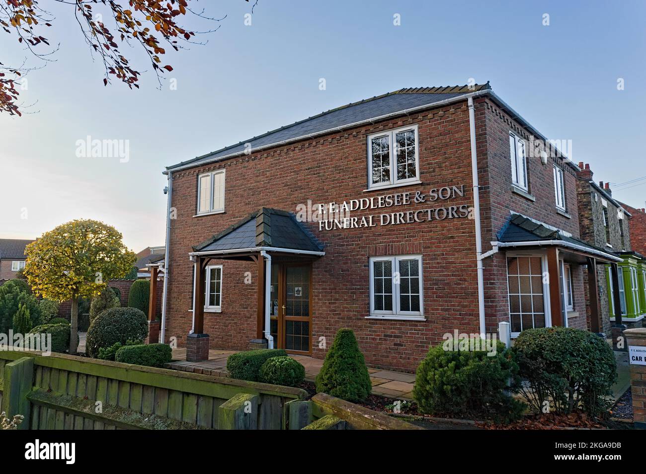 View of F.E Addlesee & Son Ltd, funeral home with surrounding gardens at sundown Stock Photo