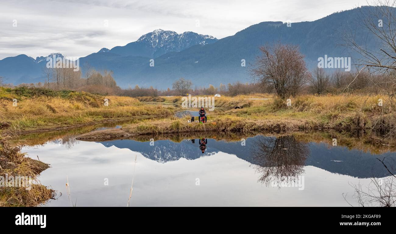 Man fishing on a lake. Beautiful autumn landscape of mountain lake with reflection. Canadian nature in the morning. Travel photo-November 11,2022-Pitt Stock Photo