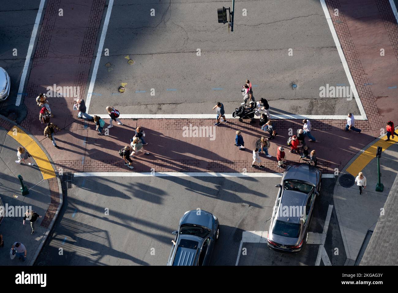 An aerial view of a group of tourists crossing a street at a crosswalk in Gatlinburg, Tennessee. Stock Photo