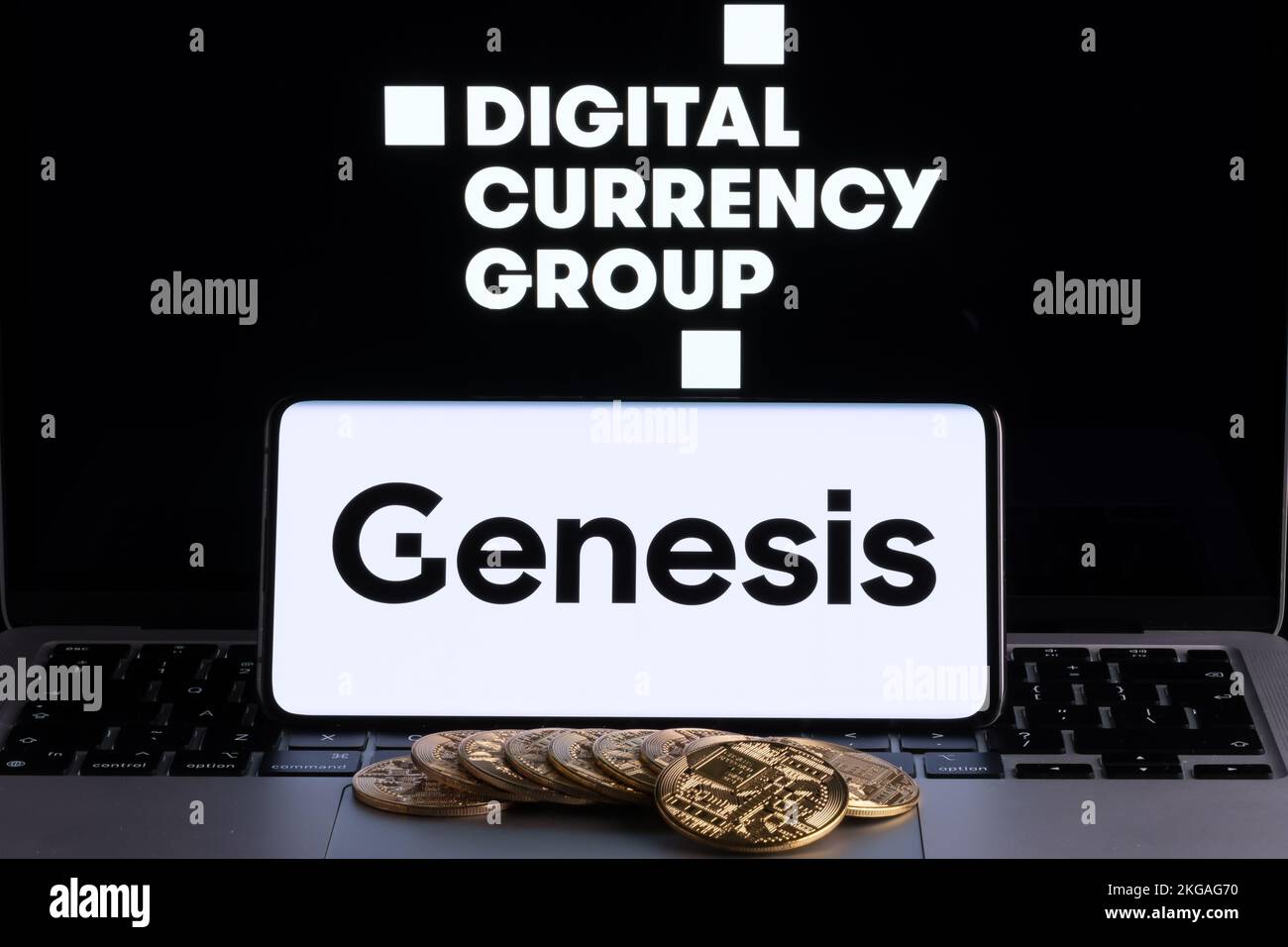 Genesis Global Trading crypto company logo seen on screen of smartphone with bitcoin tokens. Crypto lender owned by Digital Currency Group. Stafford, Stock Photo
