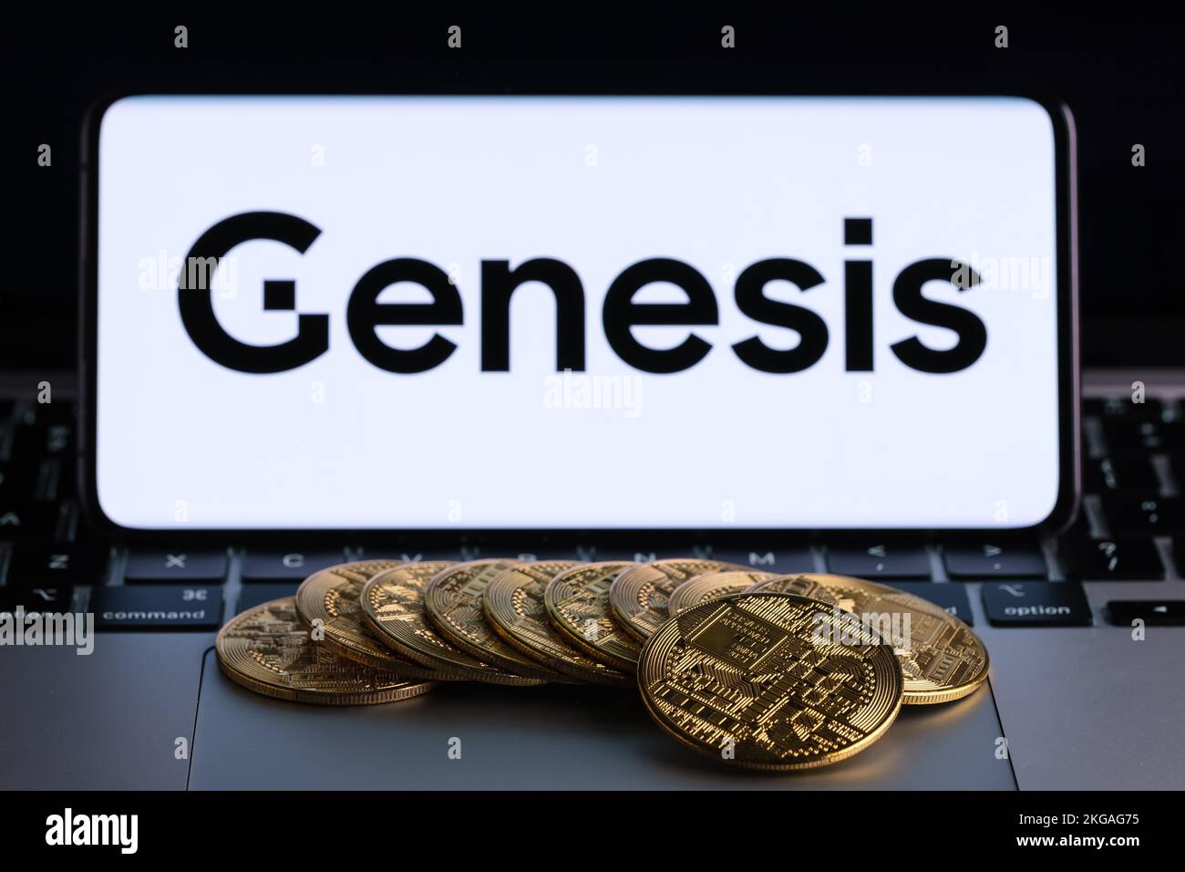 Genesis Global Trading crypto company logo seen on screen of smartphone with bitcoin tokens. Crypto lender owned by Digital Currency Group. Stafford, Stock Photo