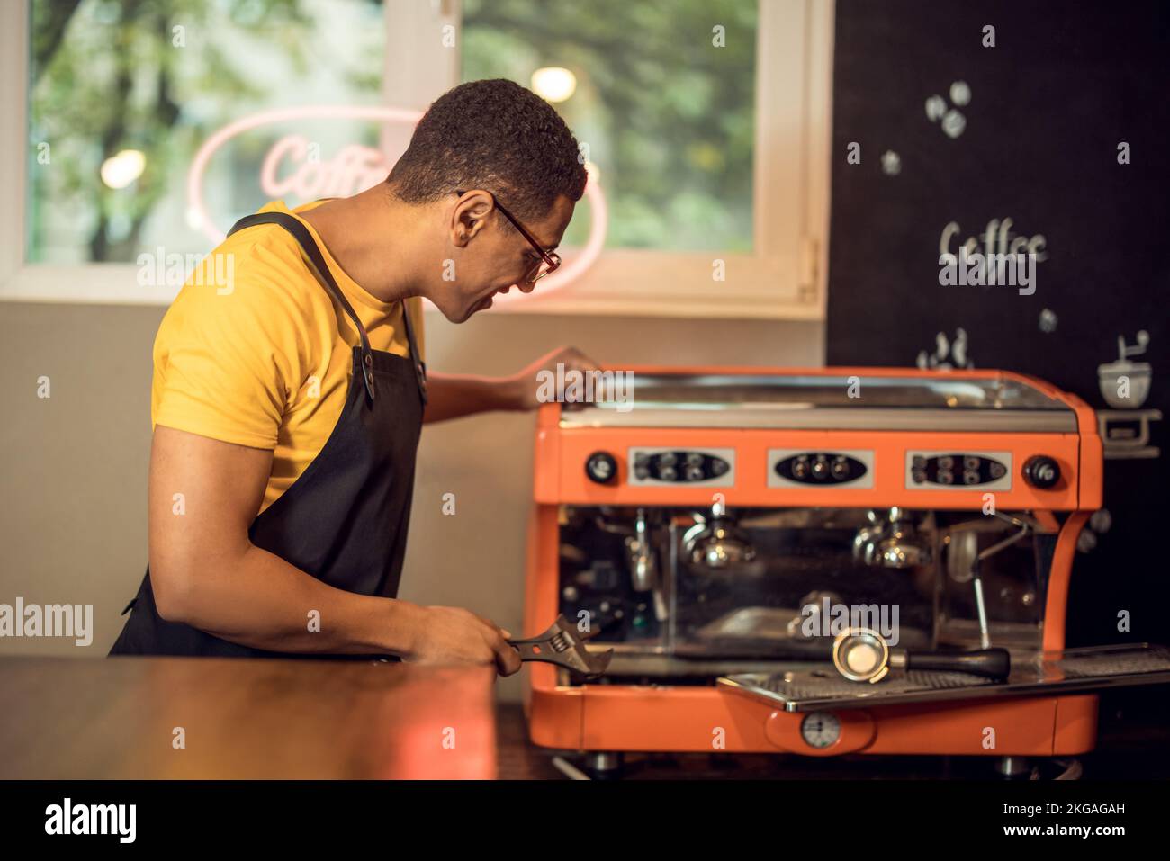 Experienced repairman preparing to repair a coffeemaker Stock Photo