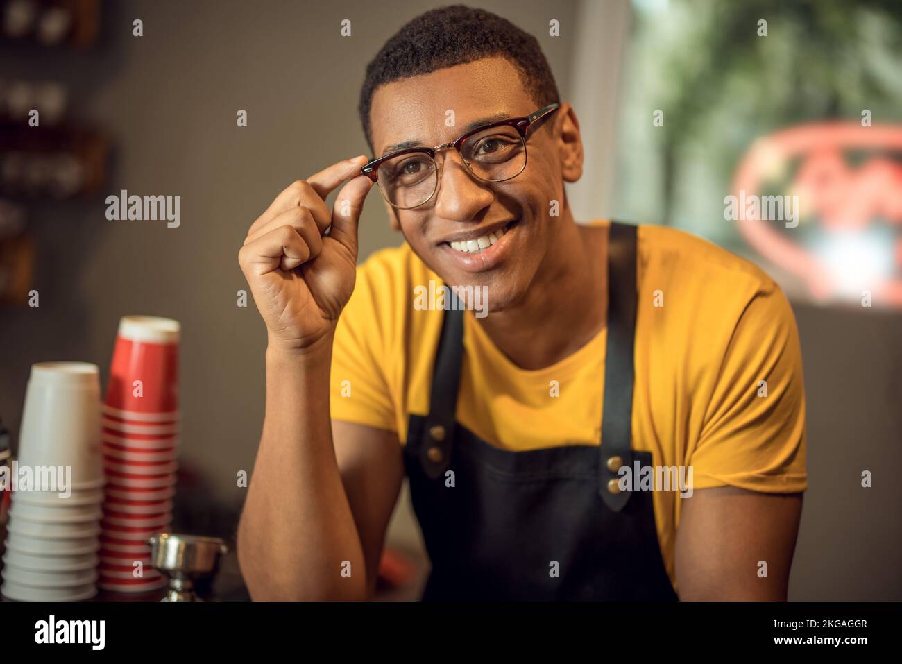 Smiling barista wearing dark hi-res stock photography and images - Alamy