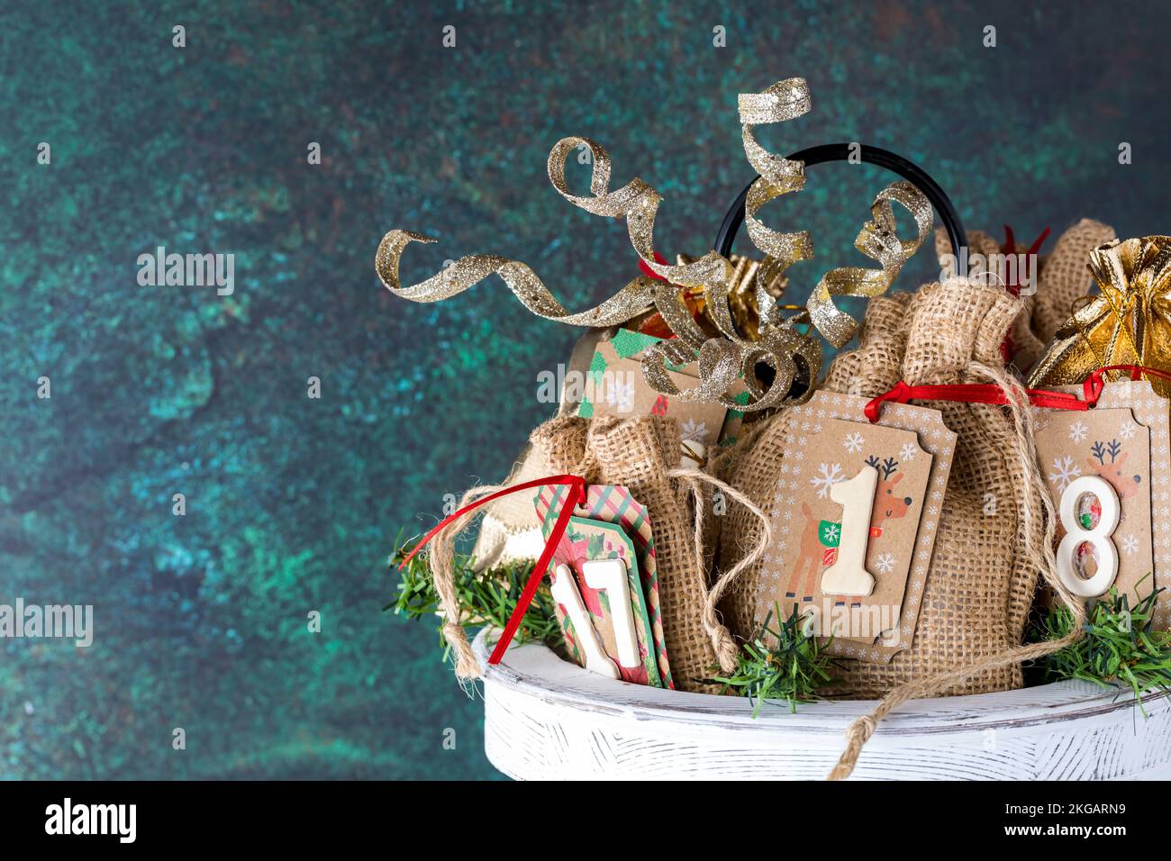 A homemade Advent calendar on a wooden tray with copy space to the left. Stock Photo