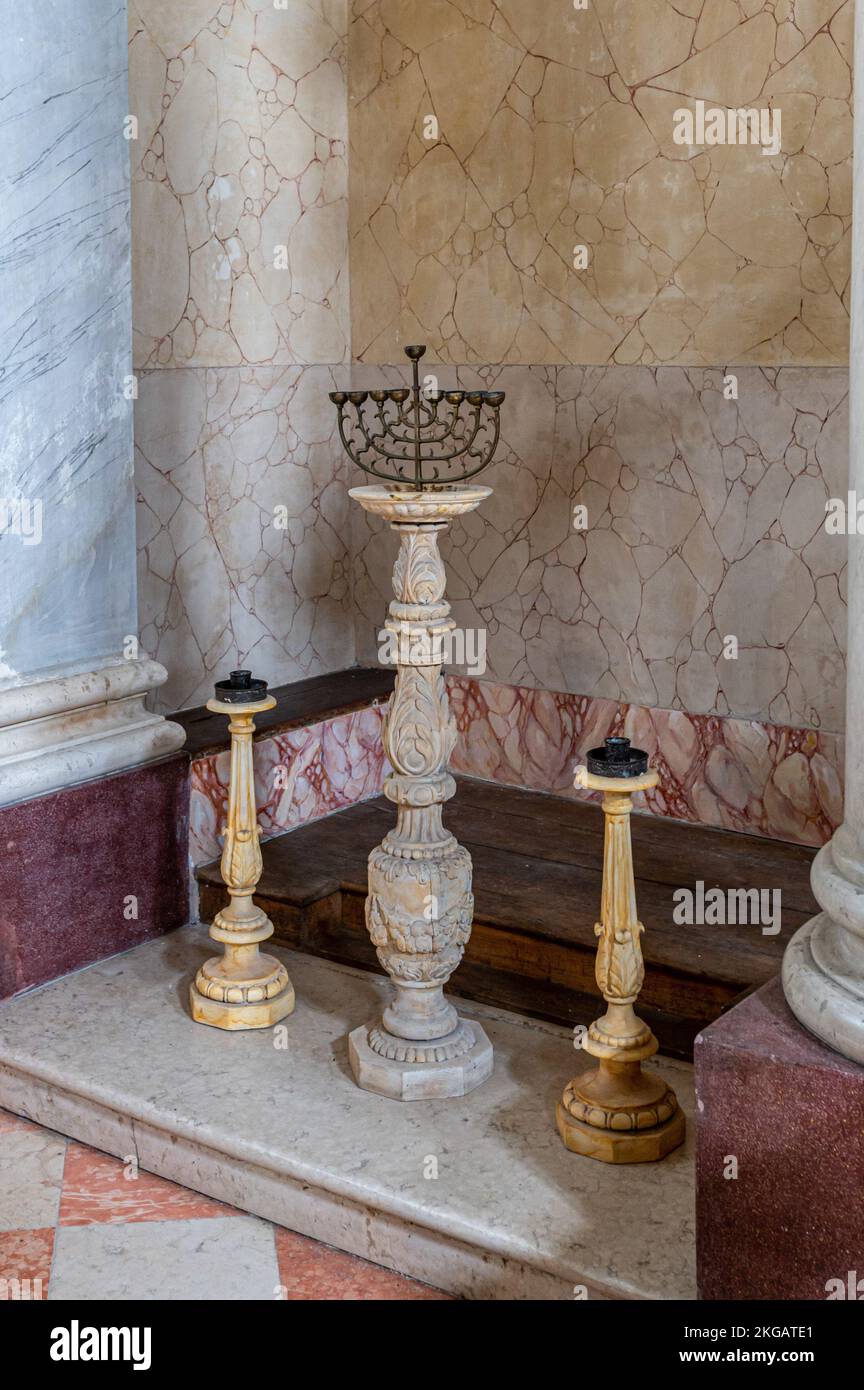 The seven-branched menorah (or candlestick) of the Hebrews is seen in the prayer room of the Sabbioneta Synagogue. In the town of Sabbioneta, created in the 16th century by Prince Vespasiano I Gonzaga Colonna according to the Renaissance model, a Jewish quarter has been delimited. The synagogue was built in 1824 and has been a UNESCO World Heritage Site since 2008. It can be visited by tourists with a small museum that tells its history. Stock Photo