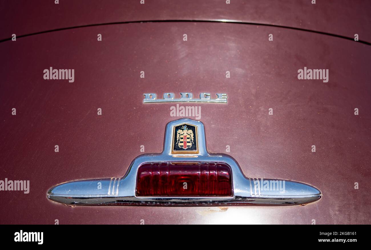 NISSWA, MN – 30 JUL 2022: Tail light and logo on the trunk of an old restored Dodge automobile or car. Selective focus with shallow depth of field. Stock Photo