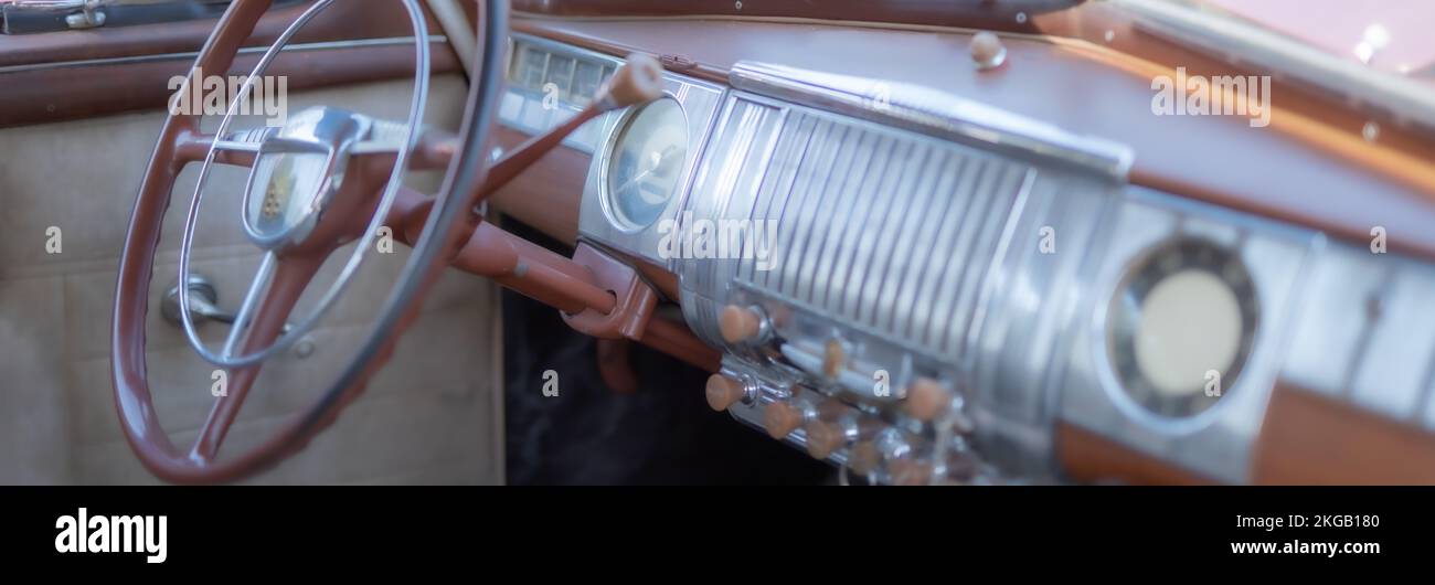 Blurred steering wheel, shifting lever and dash board of a restored