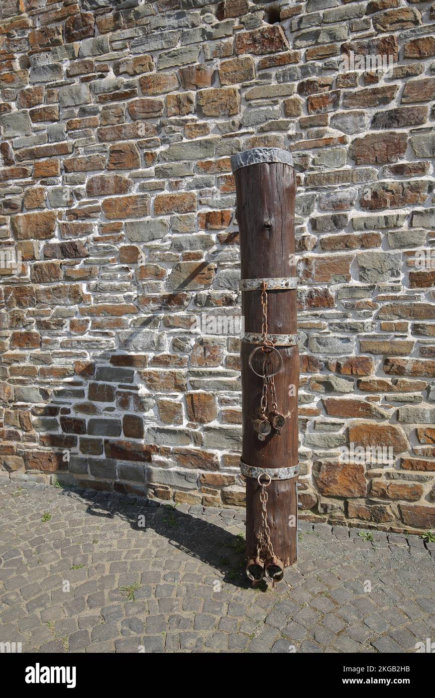 Historical pillory at the Schinderhannesturm, medieval, stake, stone wall, fittings, chain, metal ring, Simmern, Hunsrück, Rhineland-Palatinate, Germa Stock Photo