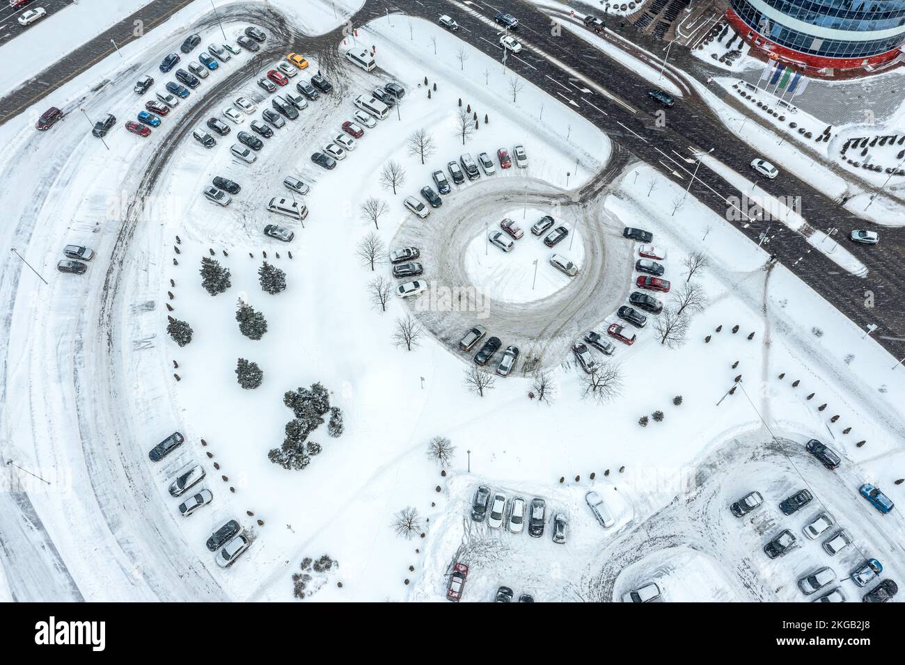 parking lot with many cars near shopping mall during heavy snowfall ...