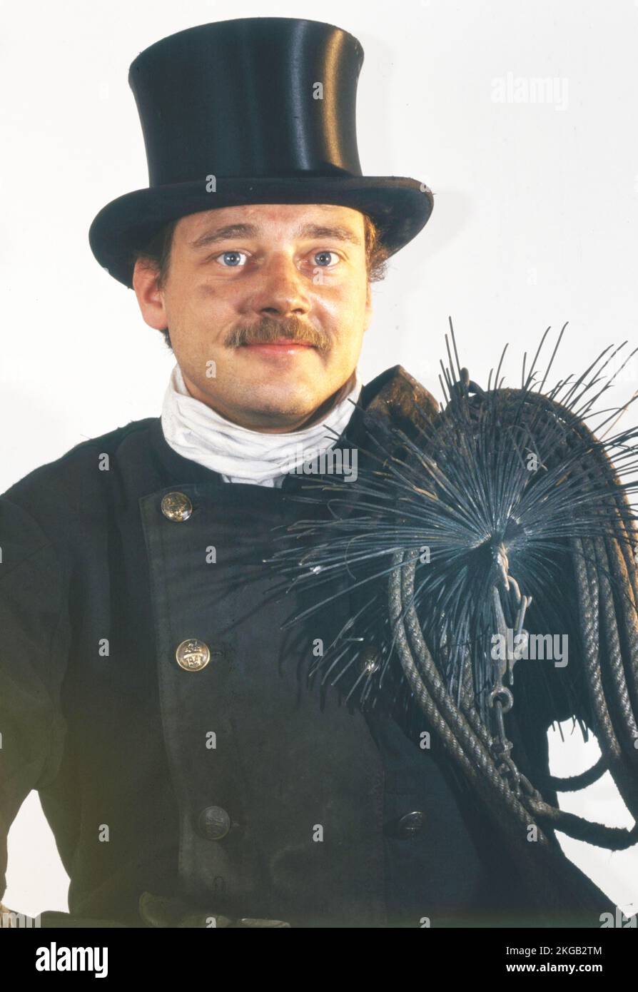 Chimney sweep in professional training and posing in a photo studio