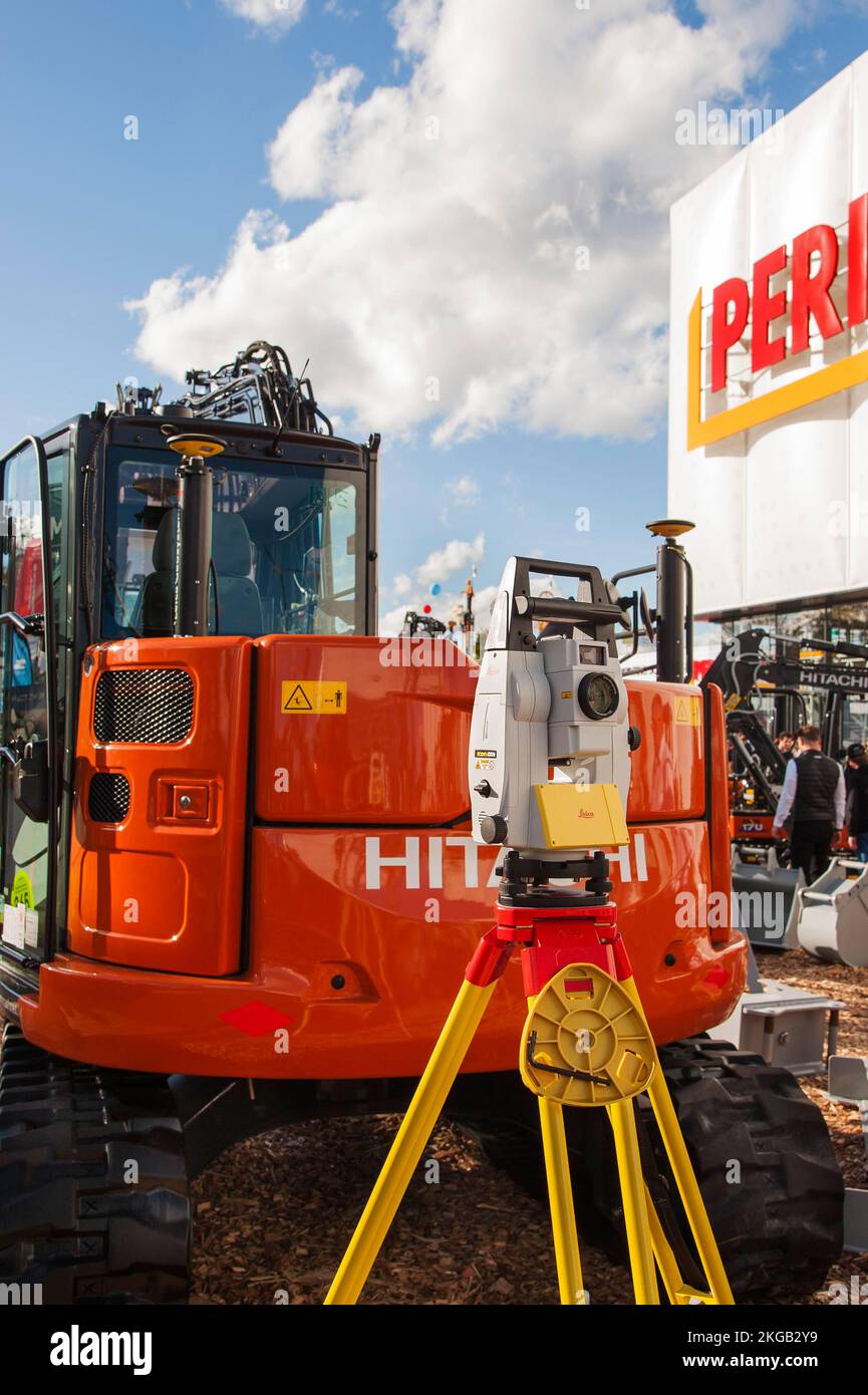 Surveying instrument in front of construction machine, Bauma 2022