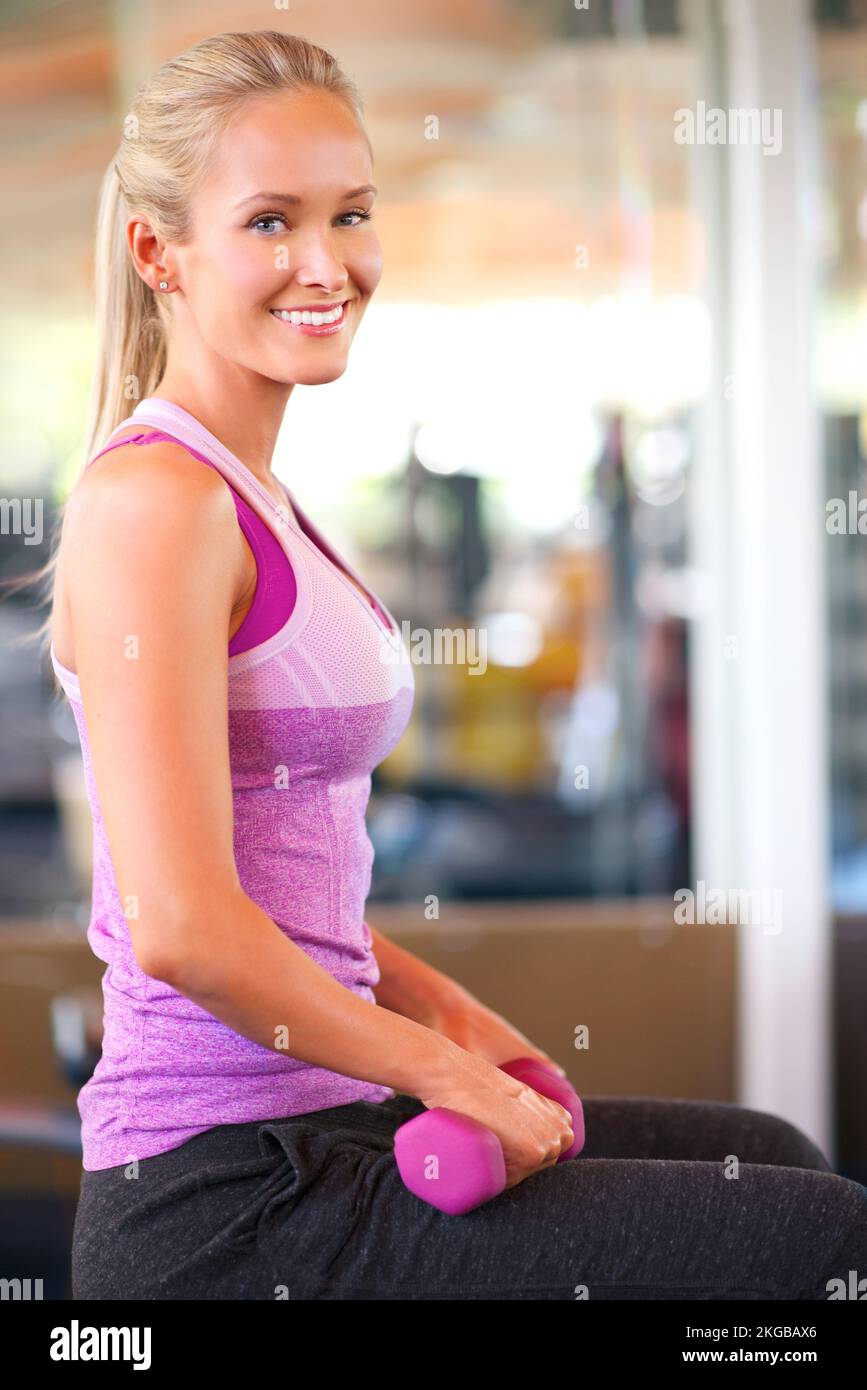 Try and fail but dont fail to try. a young woman lifting weights Stock ...