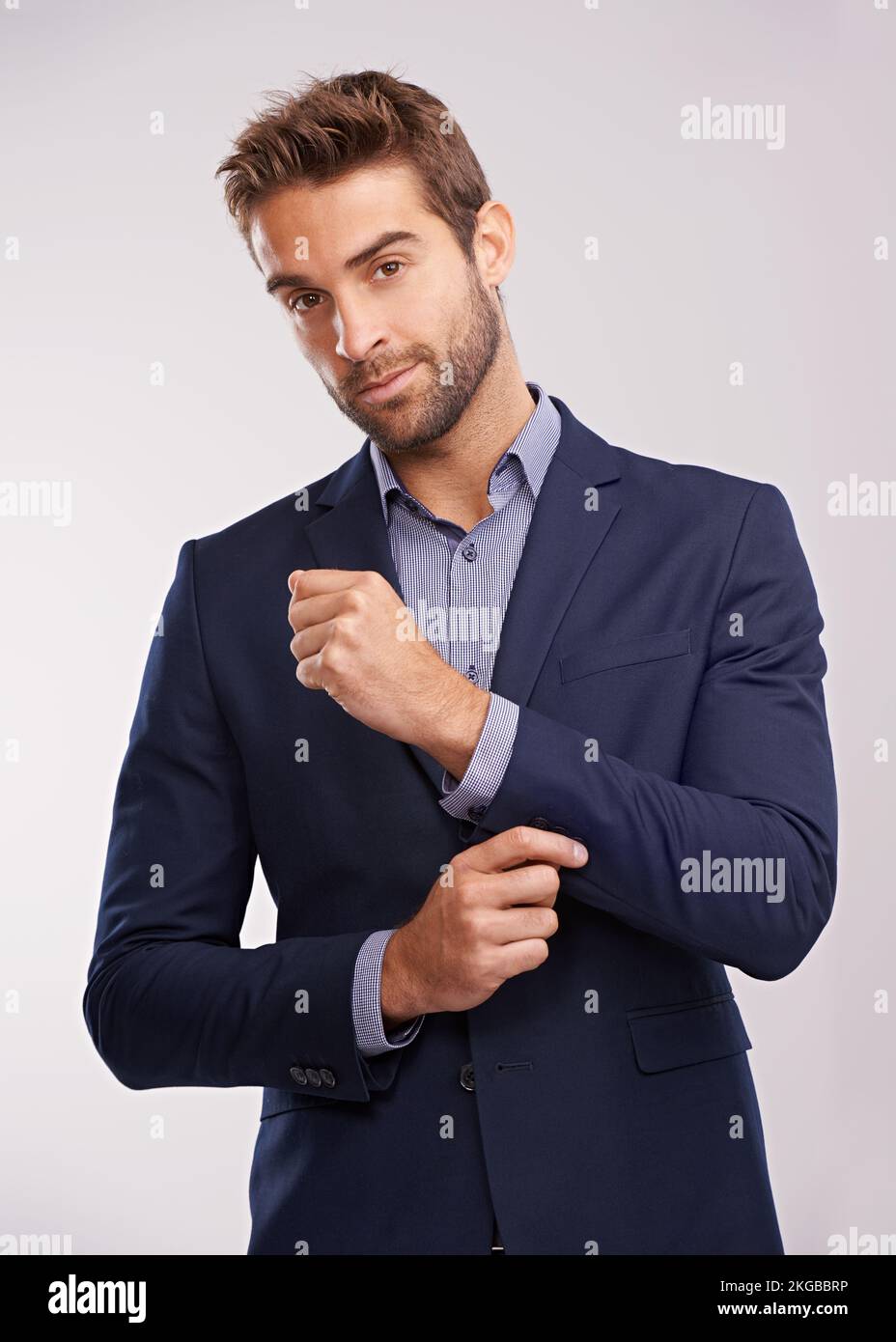 Dressed to impress. Studio portrait of a handsome well-dressed man against a gray background. Stock Photo