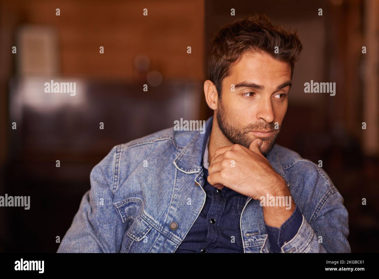 Let me think about it...a handsome young man wearing denim clothing. Stock Photo