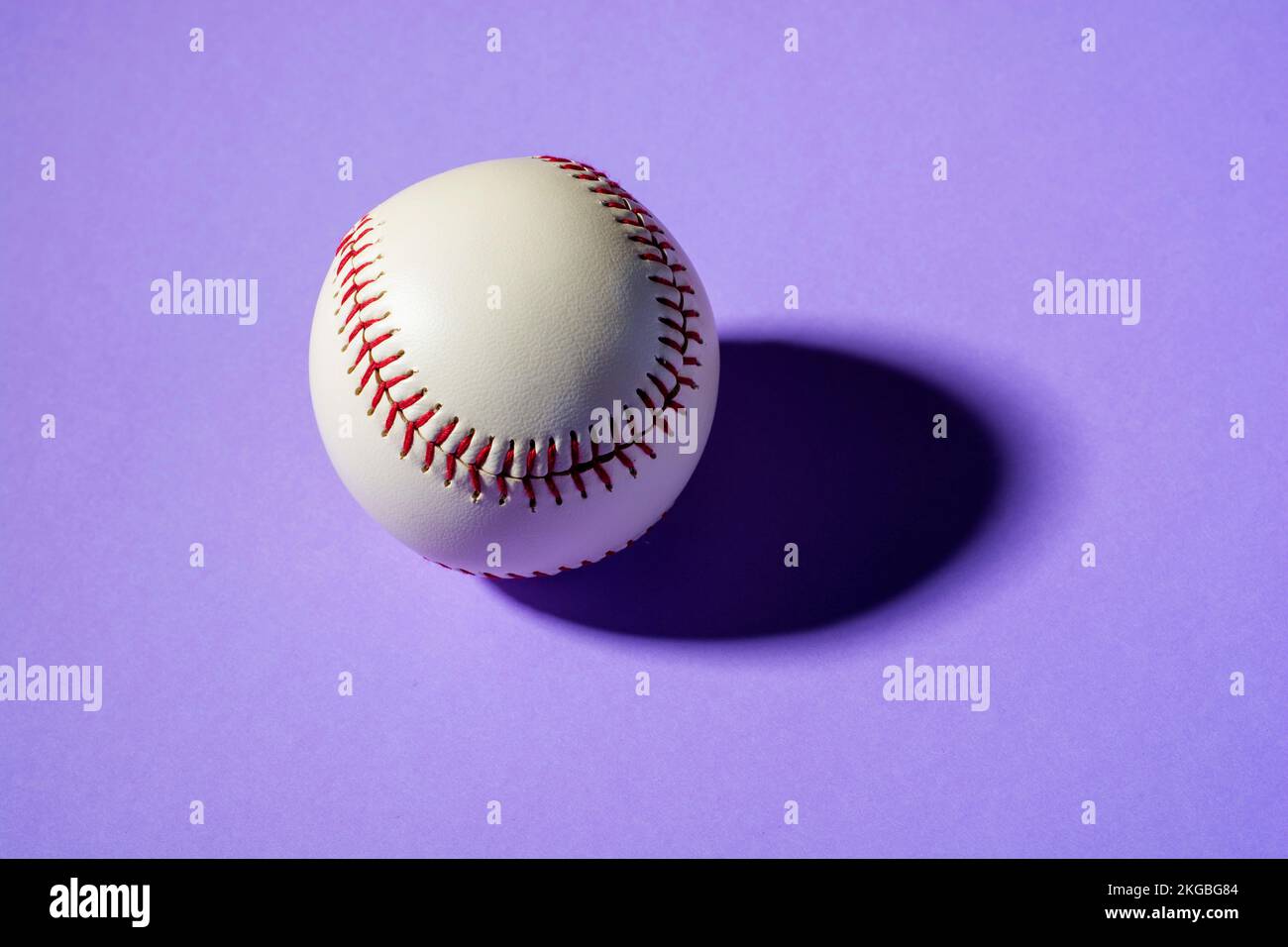 baseball ball on violet background close up with shadow. Stock Photo
