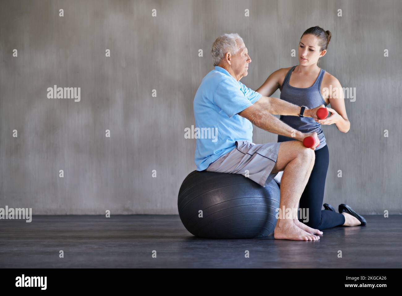 Seeing him through physio. a a physical therapist working with a senior man. Stock Photo
