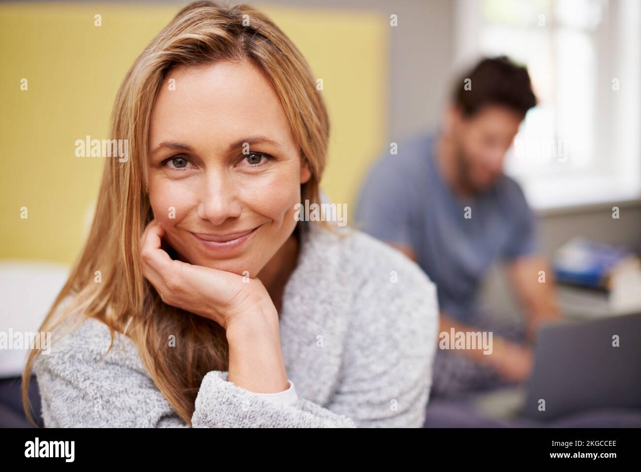 We support each other in our marriage. Portrait of a beautiful woman with her husband sitting in the background. Stock Photo