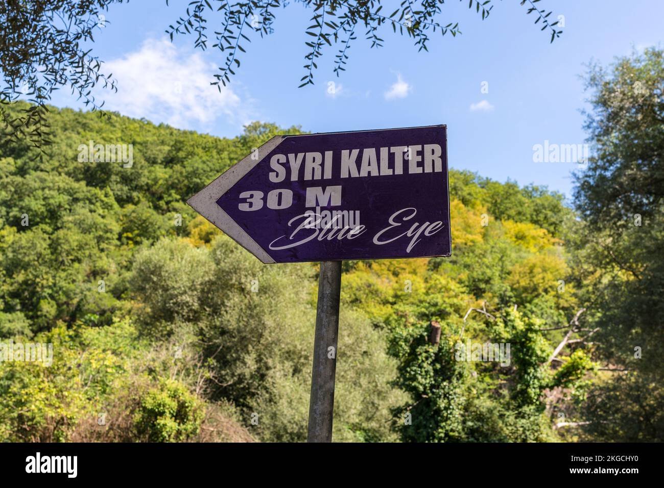 Vlora County, Albania - September 10, 2021: Wooden signpost to the national landmark spring Blue Eye (Syri Kalter) in Albania. Stock Photo