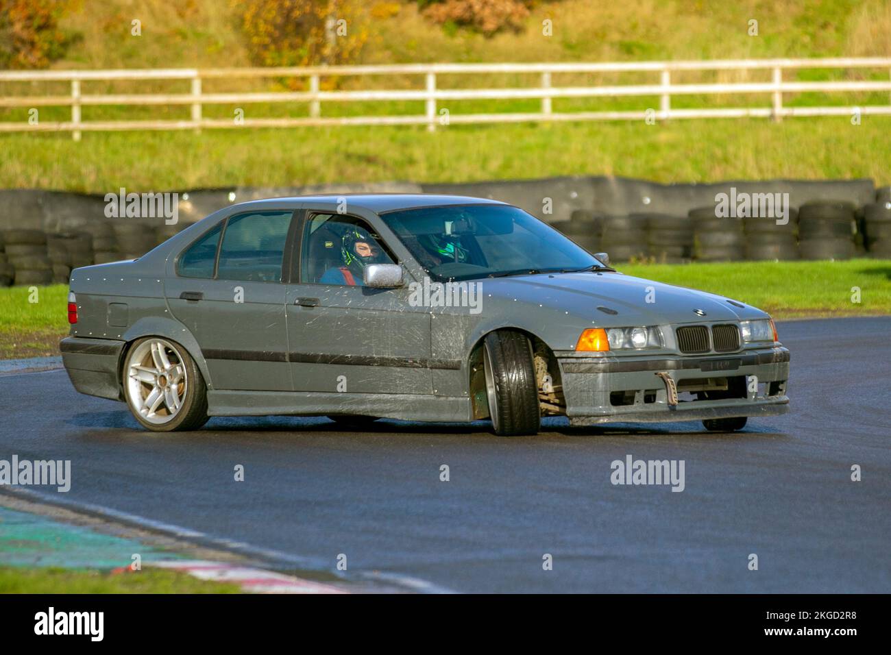 BMW Rear-wheel-drive car, driving on drift tracks and high-speed cornering on wet roads on a Three Sisters Drift Day in Wigan, UK Stock Photo