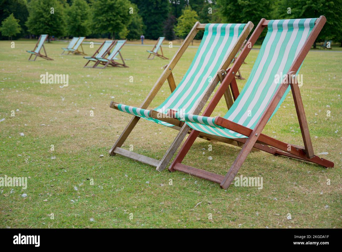 A selective of light blue and white striped deck chairs in Hyde Park