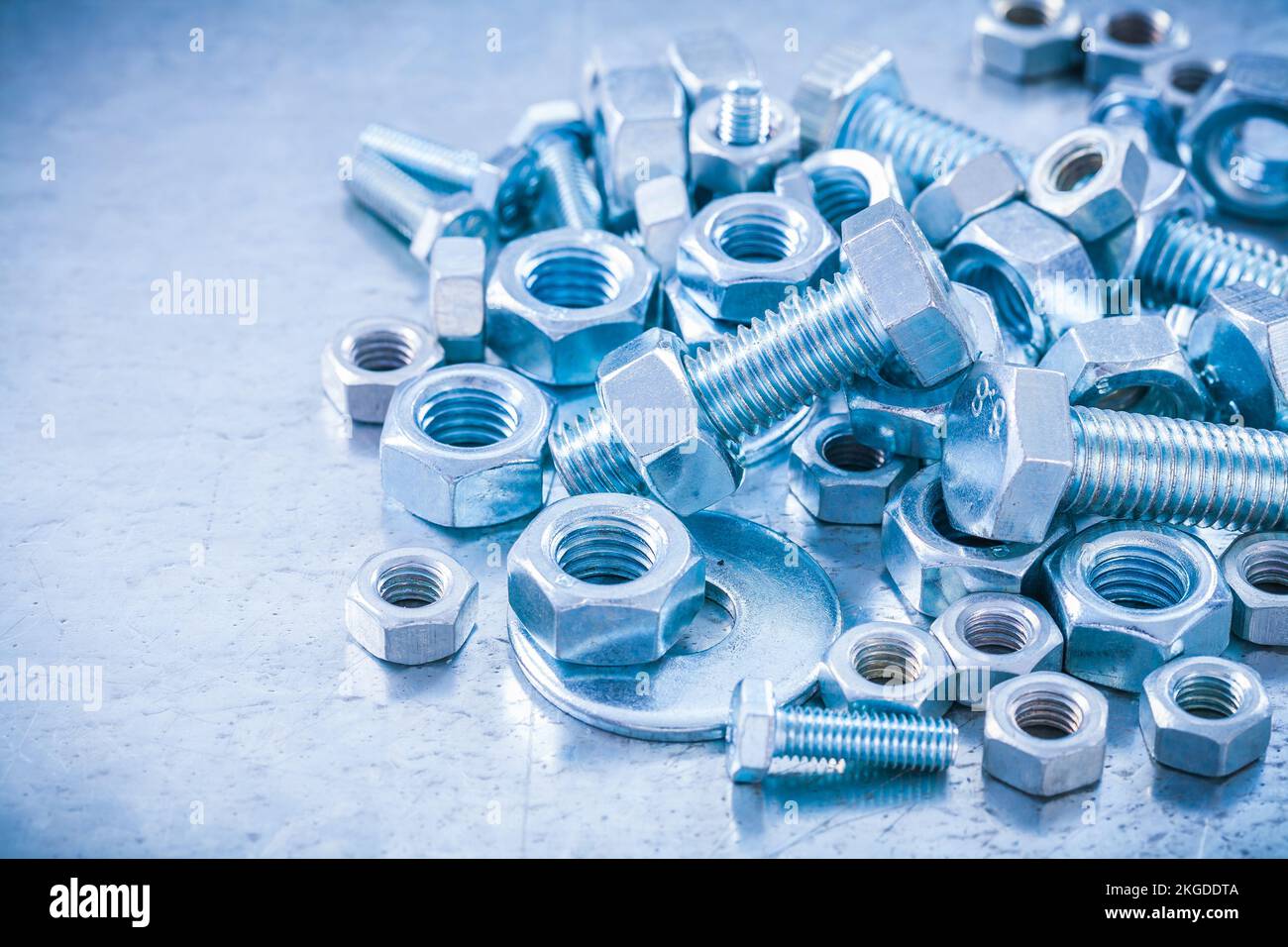 Big stack of metal threaded screwbolts nuts and bolt washers on