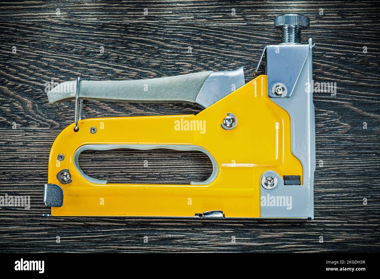 Building stapler gun on wooden board. Stock Photo