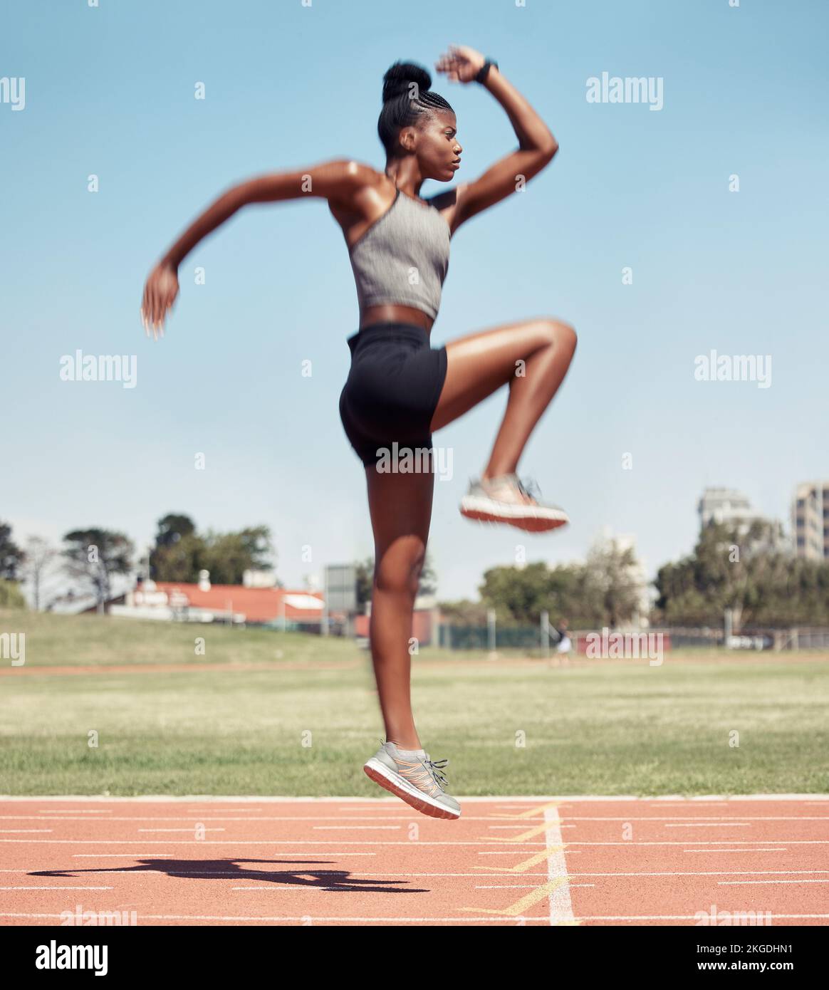 Fitness, jump or black woman runner on a race track in training, cardio