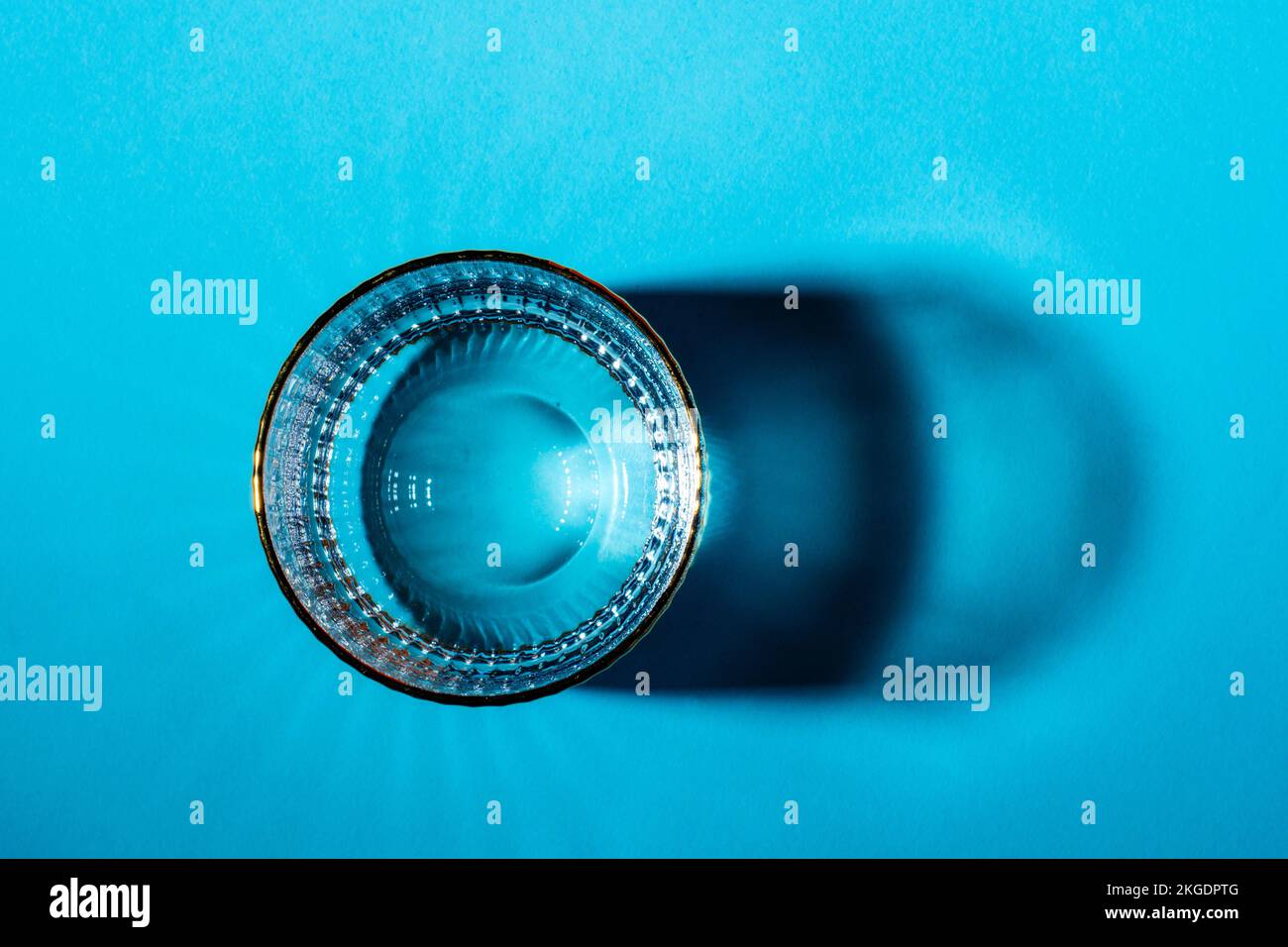 Glasses with water on blue background, top view. Stock Photo