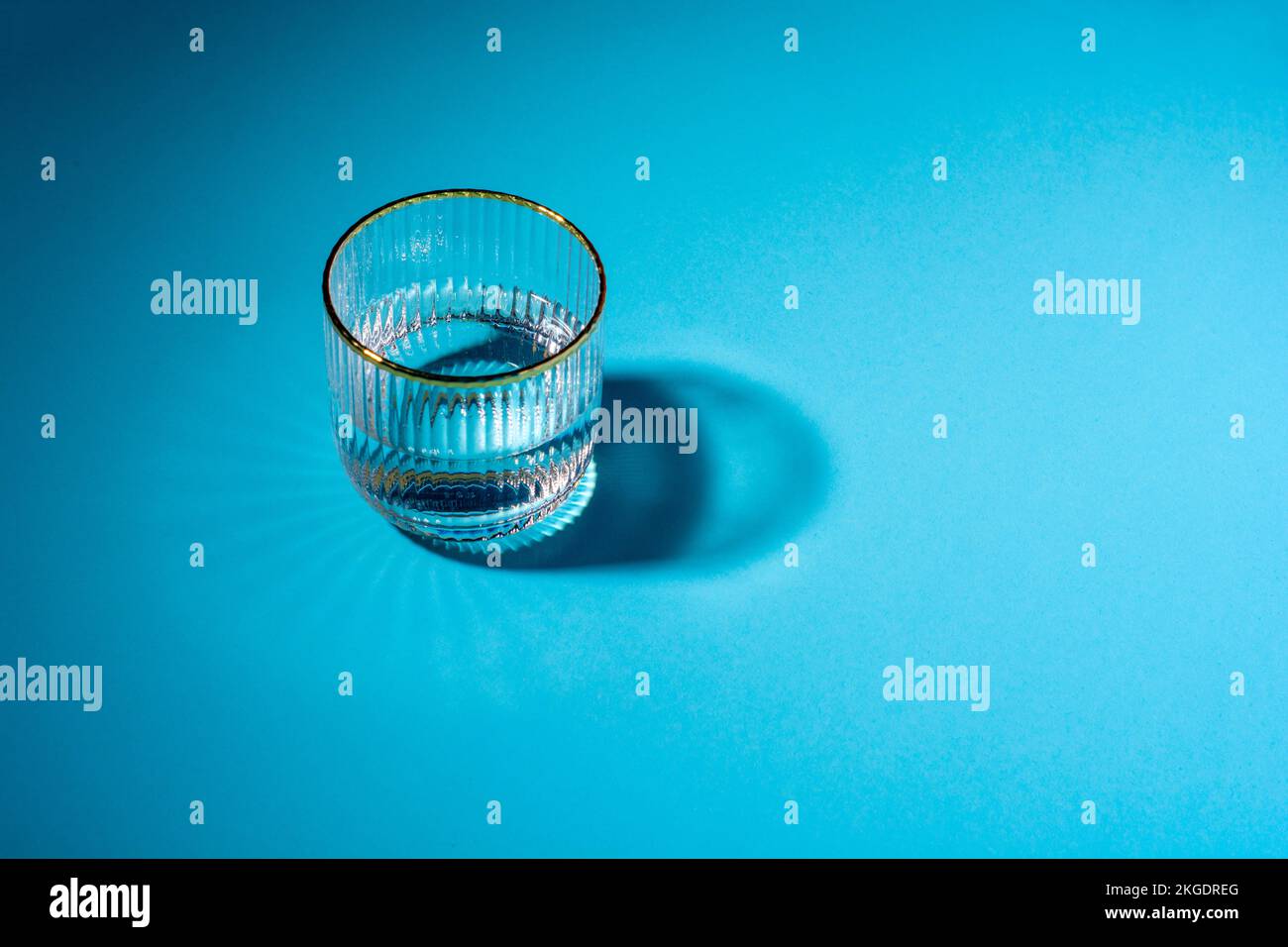 glass of water on a blue background with copy space. Stock Photo