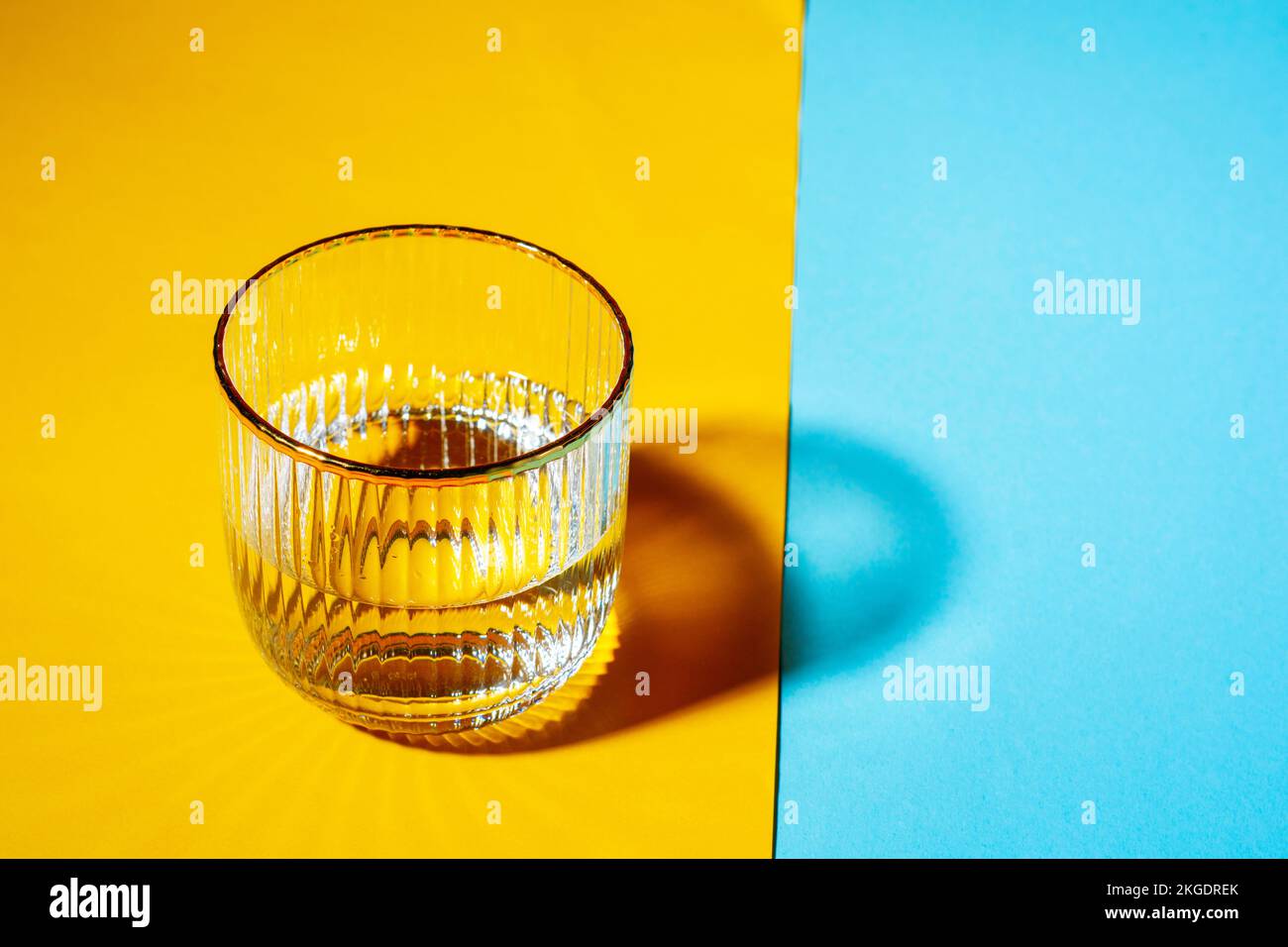 Glasses with water on two tone background with copy space. Stock Photo