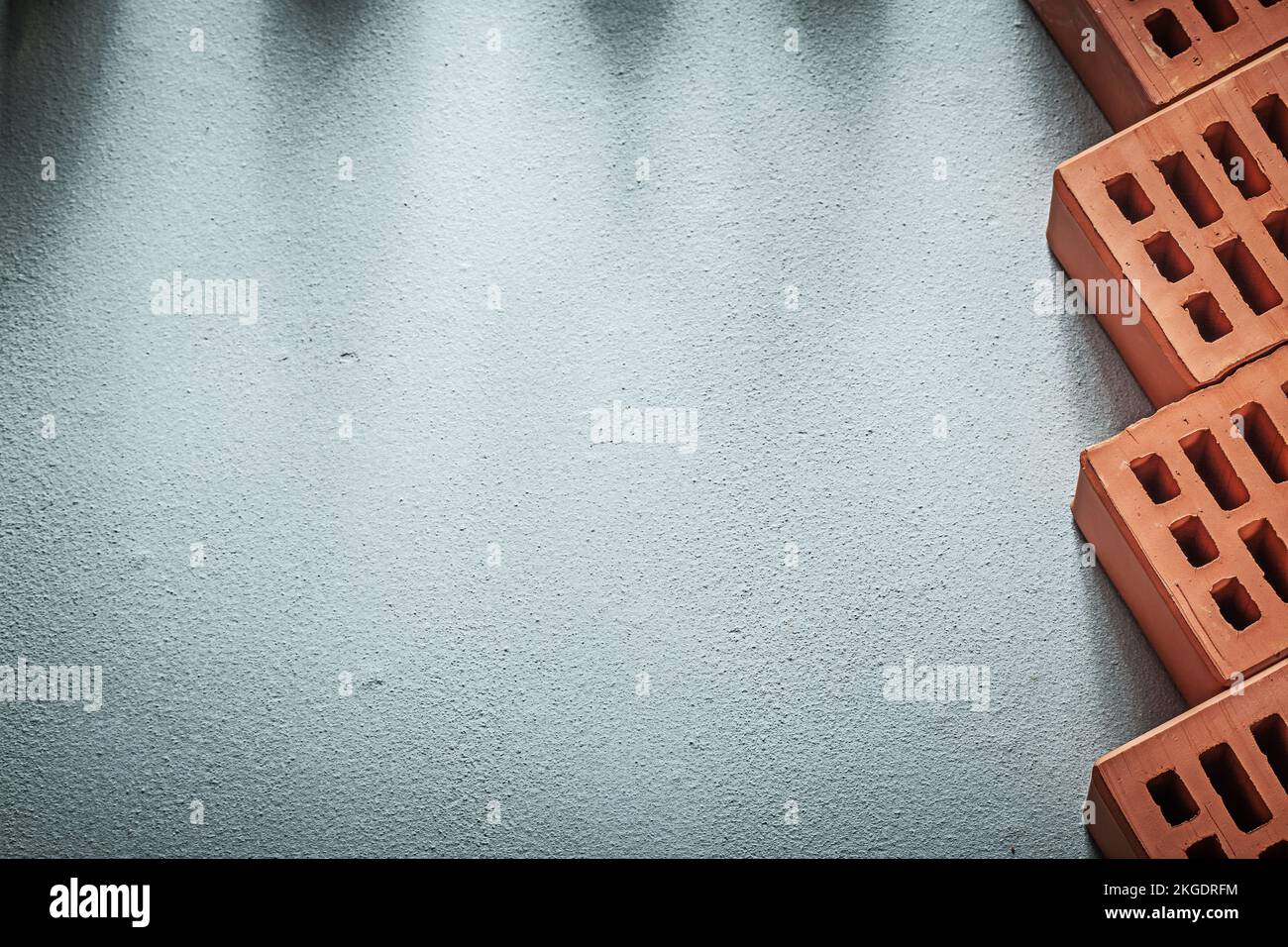 Composition of red bricks on concrete surface construction concept