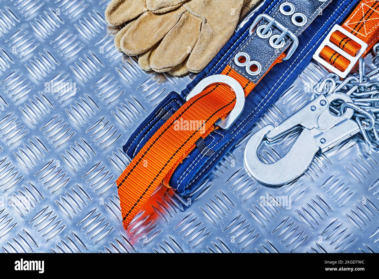 construction tools safety harness and gloves on corrugated sheet of