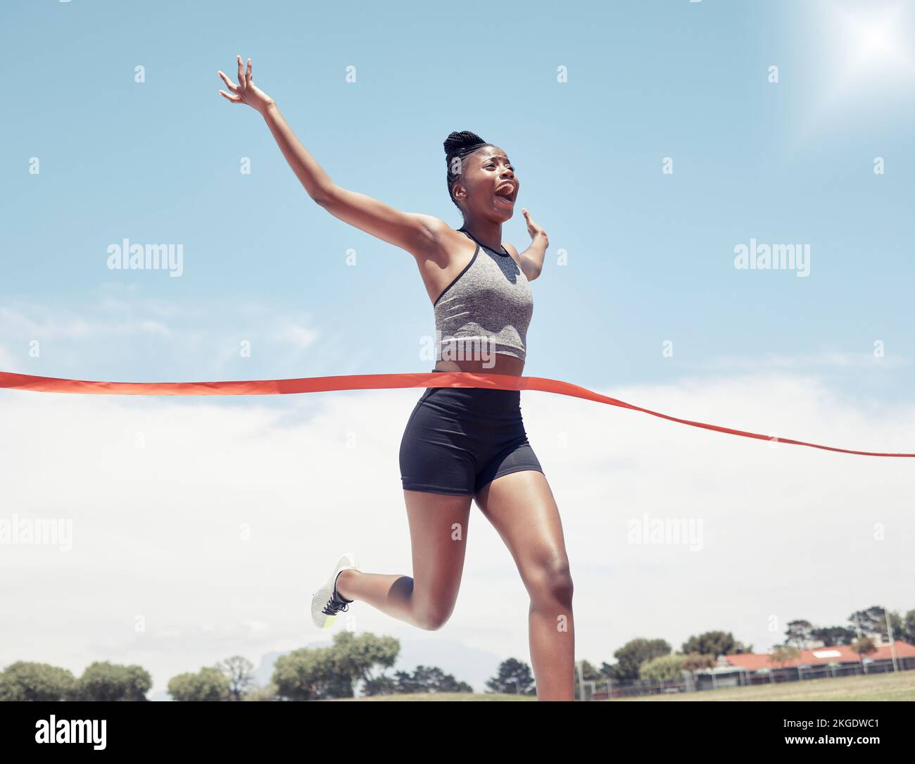 Fitness, runner winner or black woman at finish line for victory, celebration or sport exercise at stadium. Health, winning or running girl for sport Stock Photo