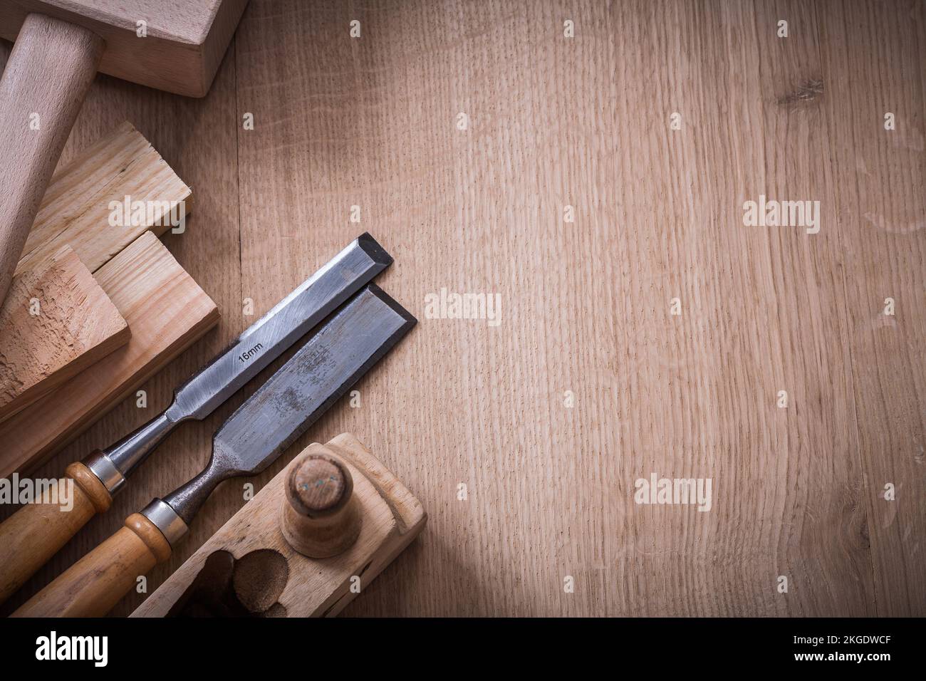 Copy space image of lump hammer planer metal firmer chisels and wooden stud on wood board construction concept. Stock Photo