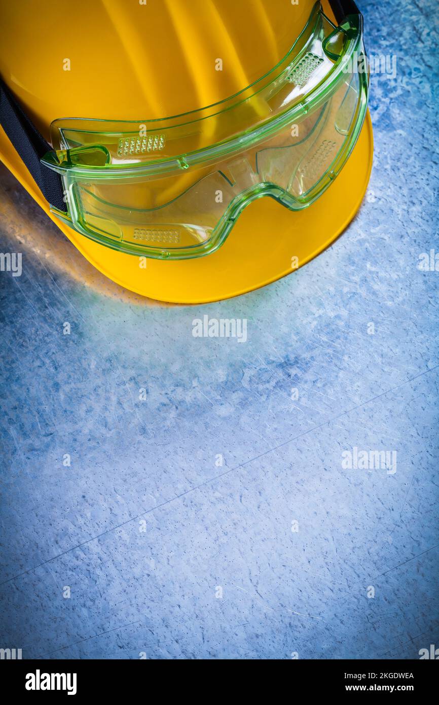 Copy space of yellow hard hat with multiplepurpose protective glasses