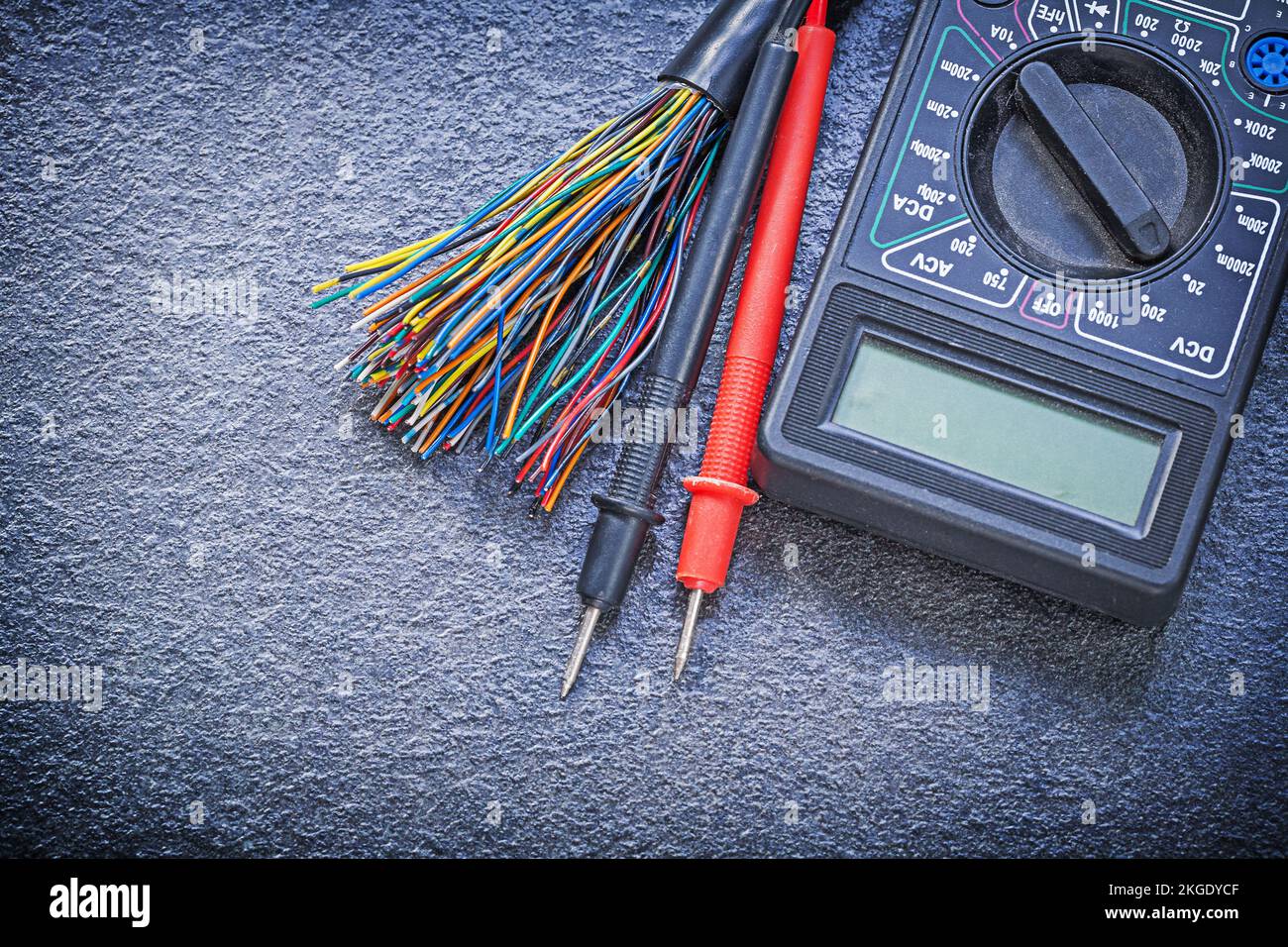 Digital multimeter electrical tester cables on black background