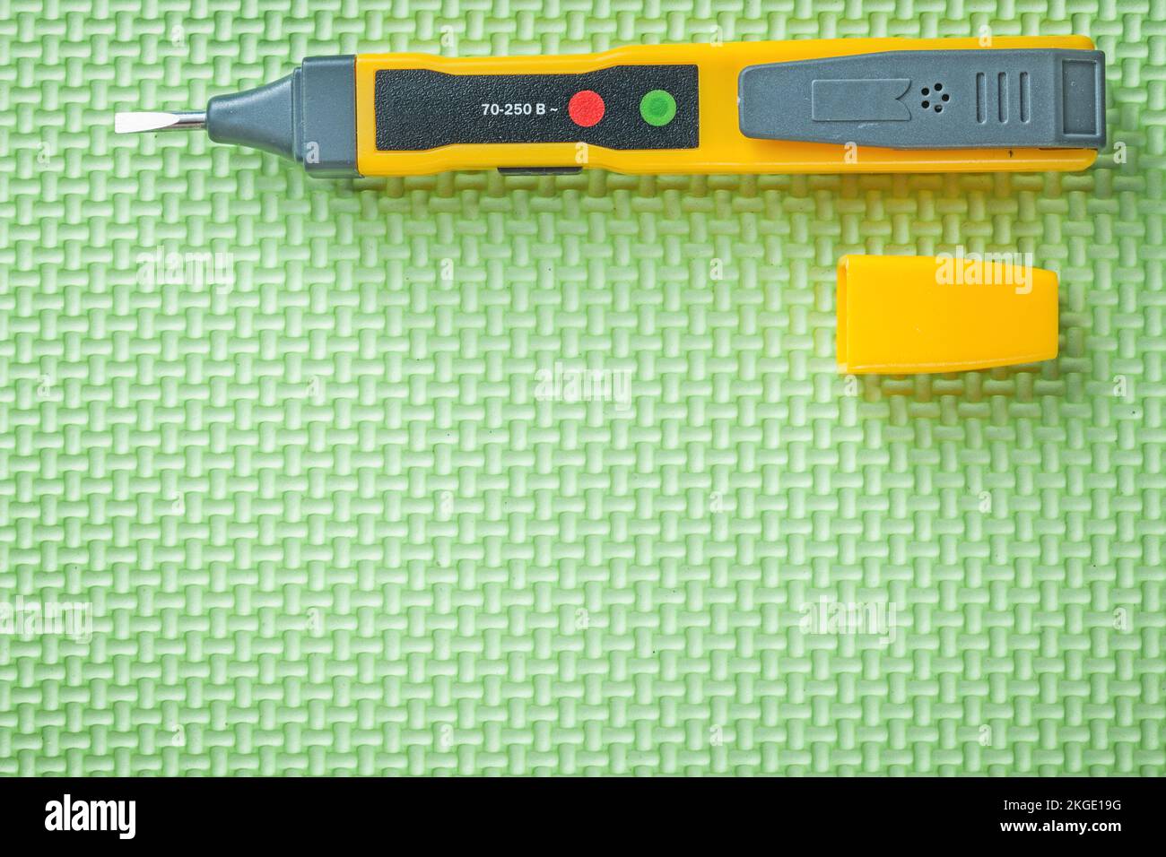 Electrical tester on green background electricity concept Stock Photo